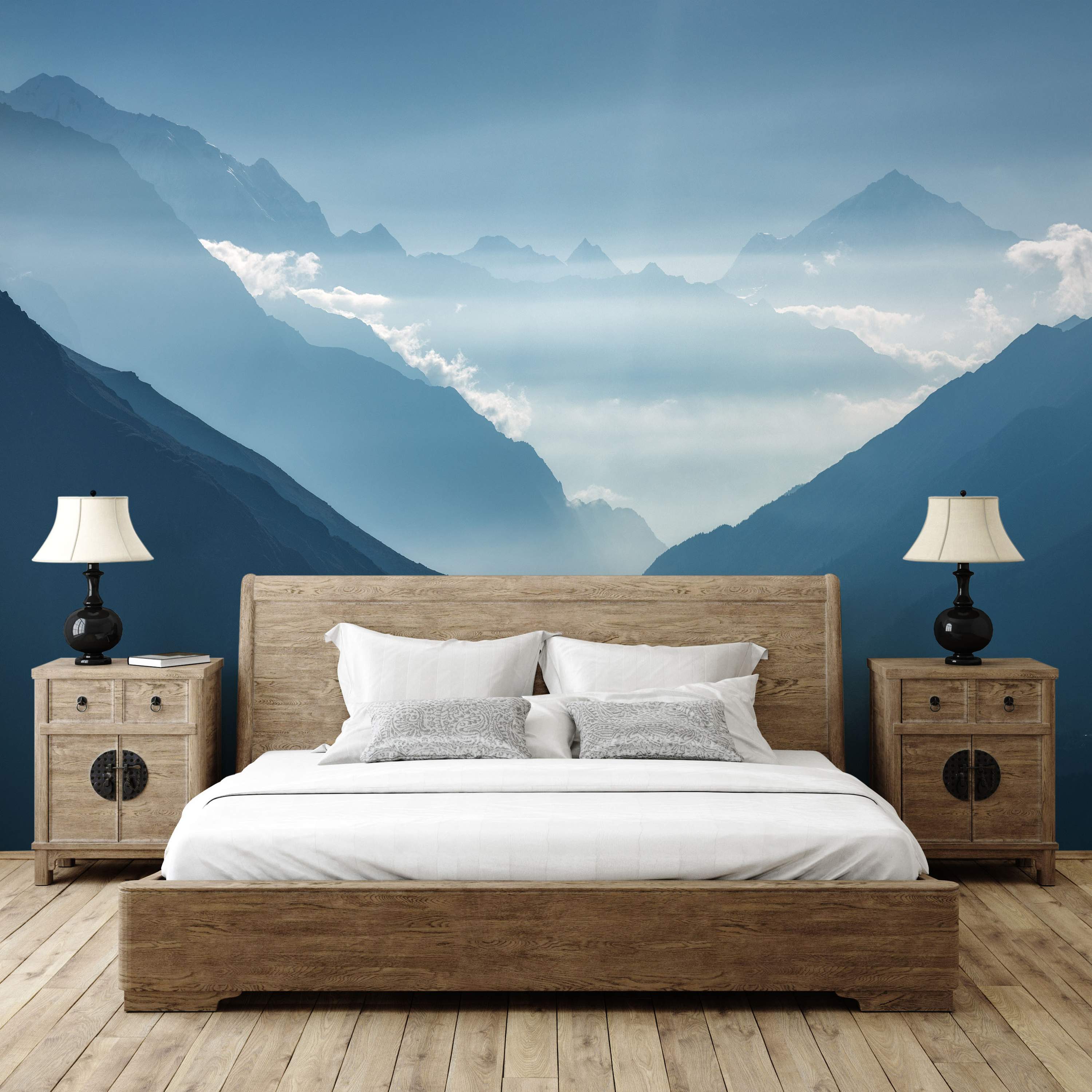 Mural featuring a scenic blue mountain range with atmospheric perspective and misty clouds settling in the valleys.