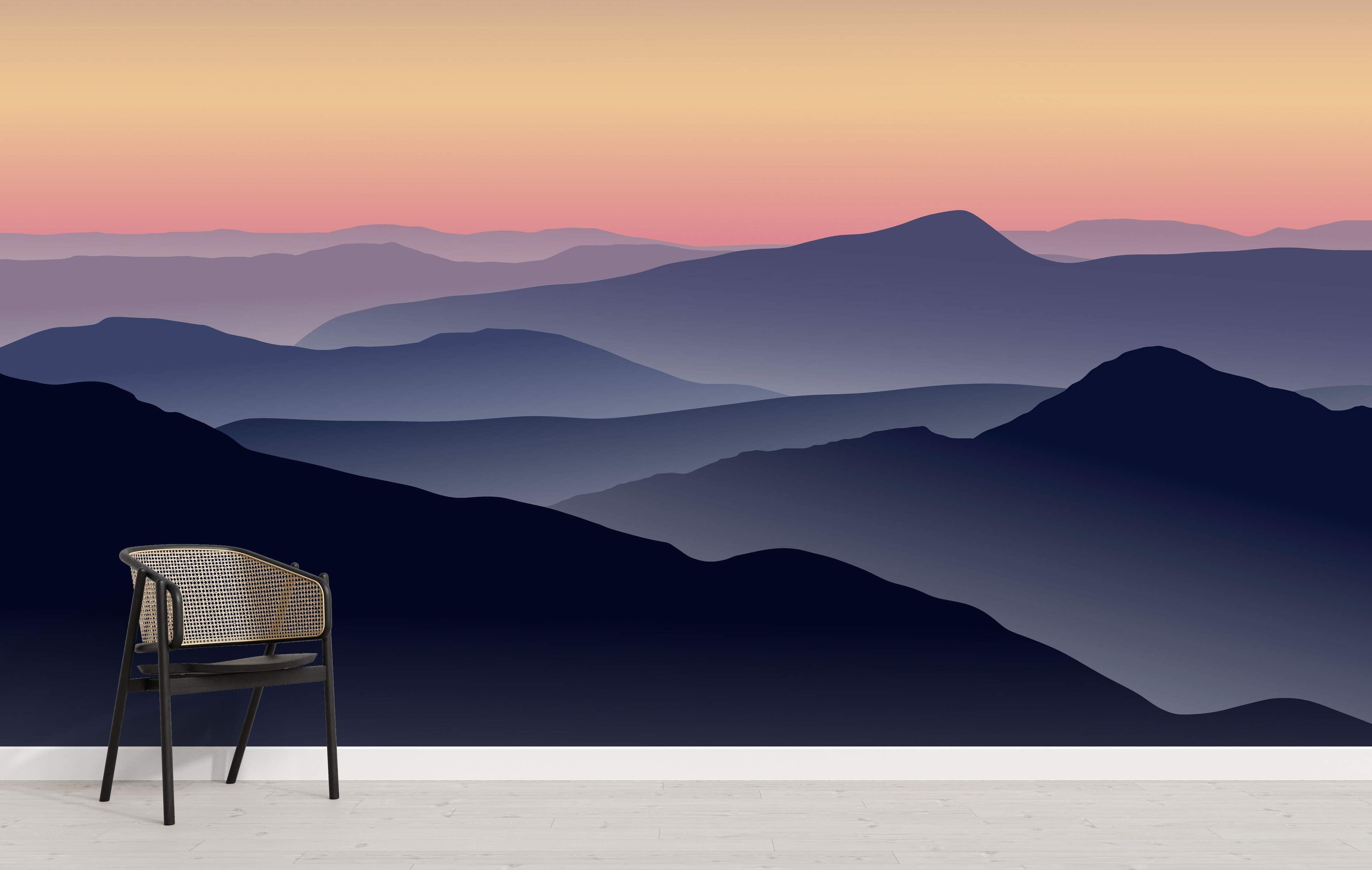Layered mountain silhouette mural in blues and purples under a pink and orange gradient sunset sky.