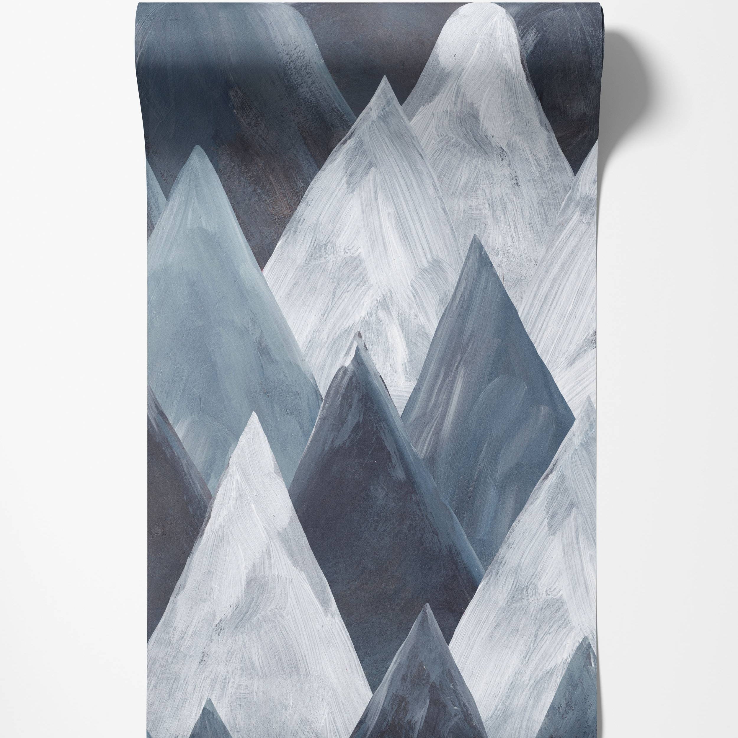 Abstract geometric mountain wallpaper with a painterly texture in shades of blue, gray, and white.