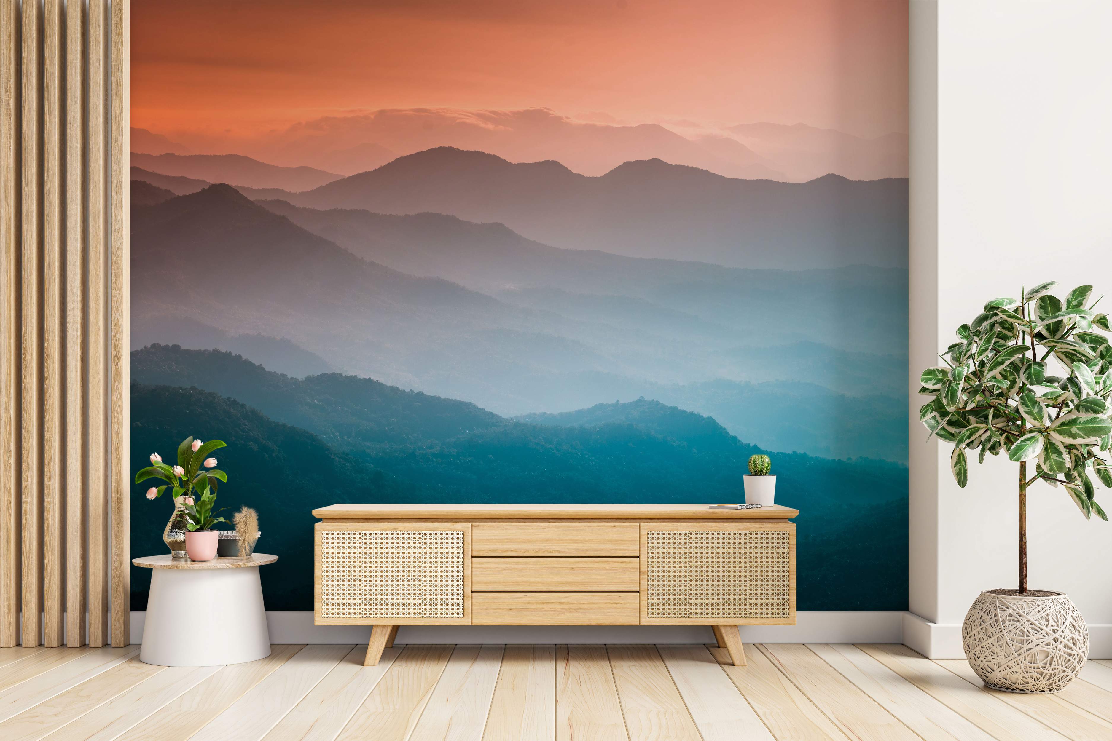 Mural featuring hazy, layered mountains under a sky shifting from warm orange at the top to cool blue at the bottom.