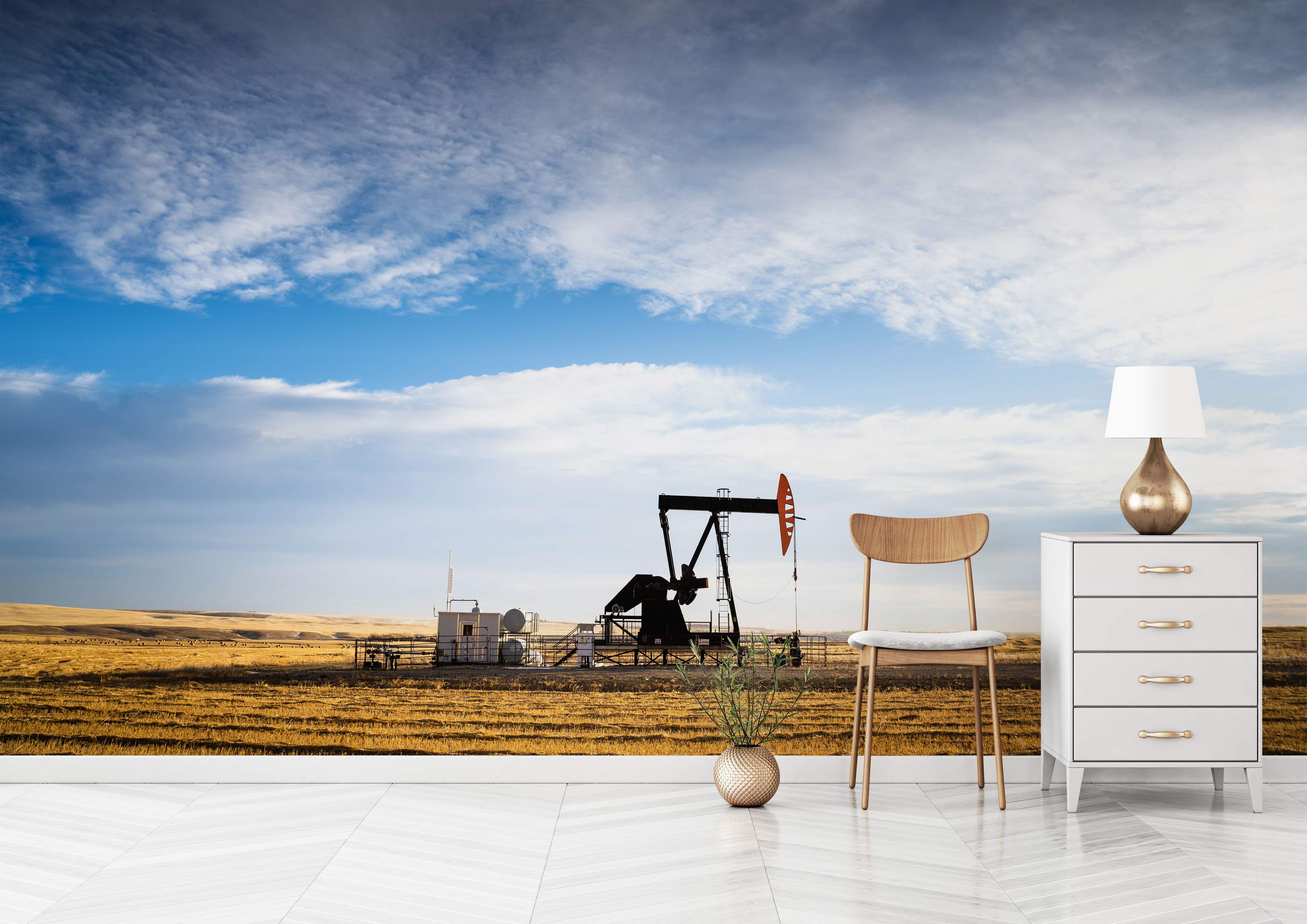 Mural depicting an oil pump jack in a golden field under a wide blue sky with scattered white clouds.