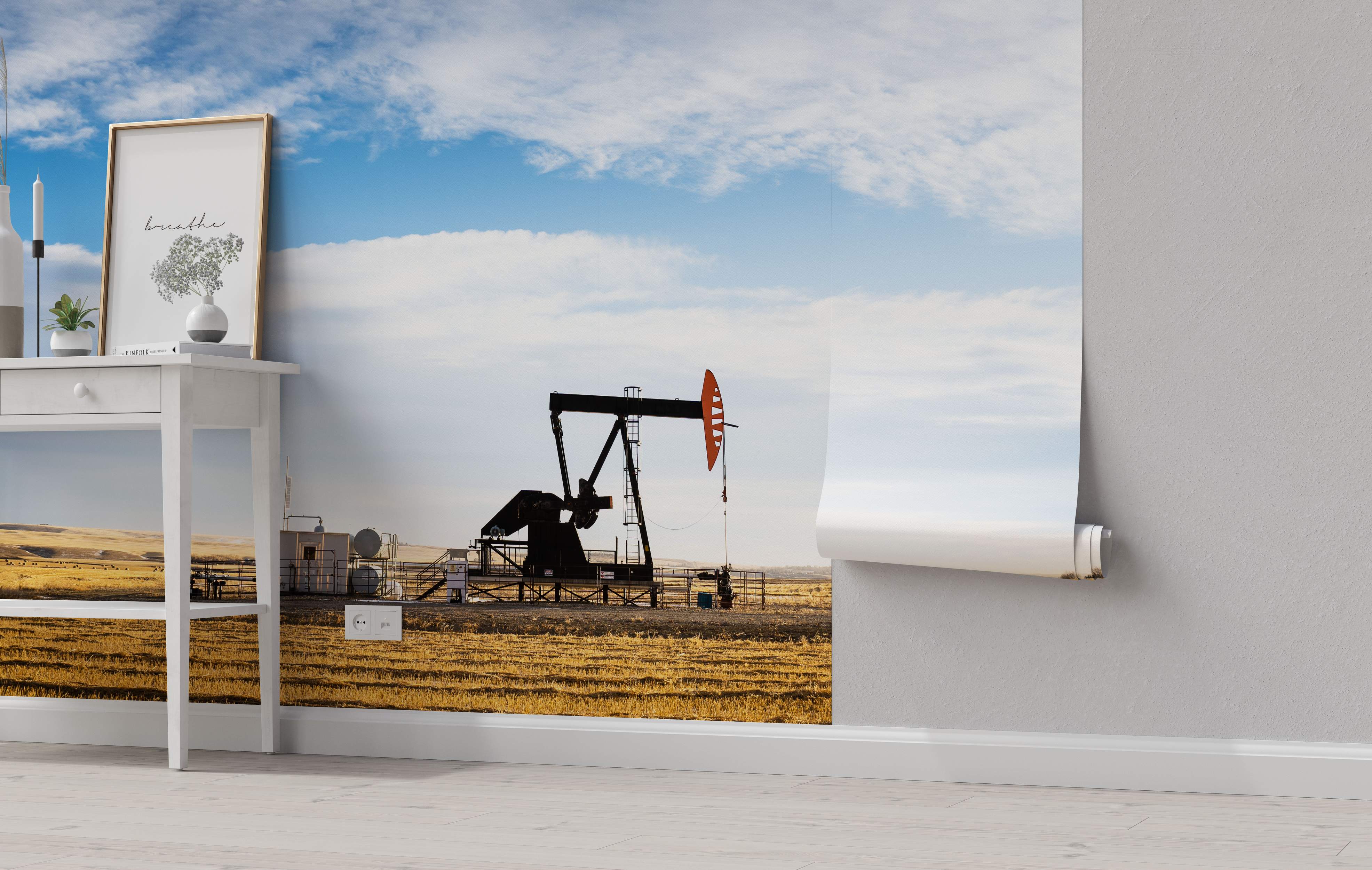 Photographic mural depicting an oil pumpjack in a golden harvested field under a bright blue sky with white clouds.