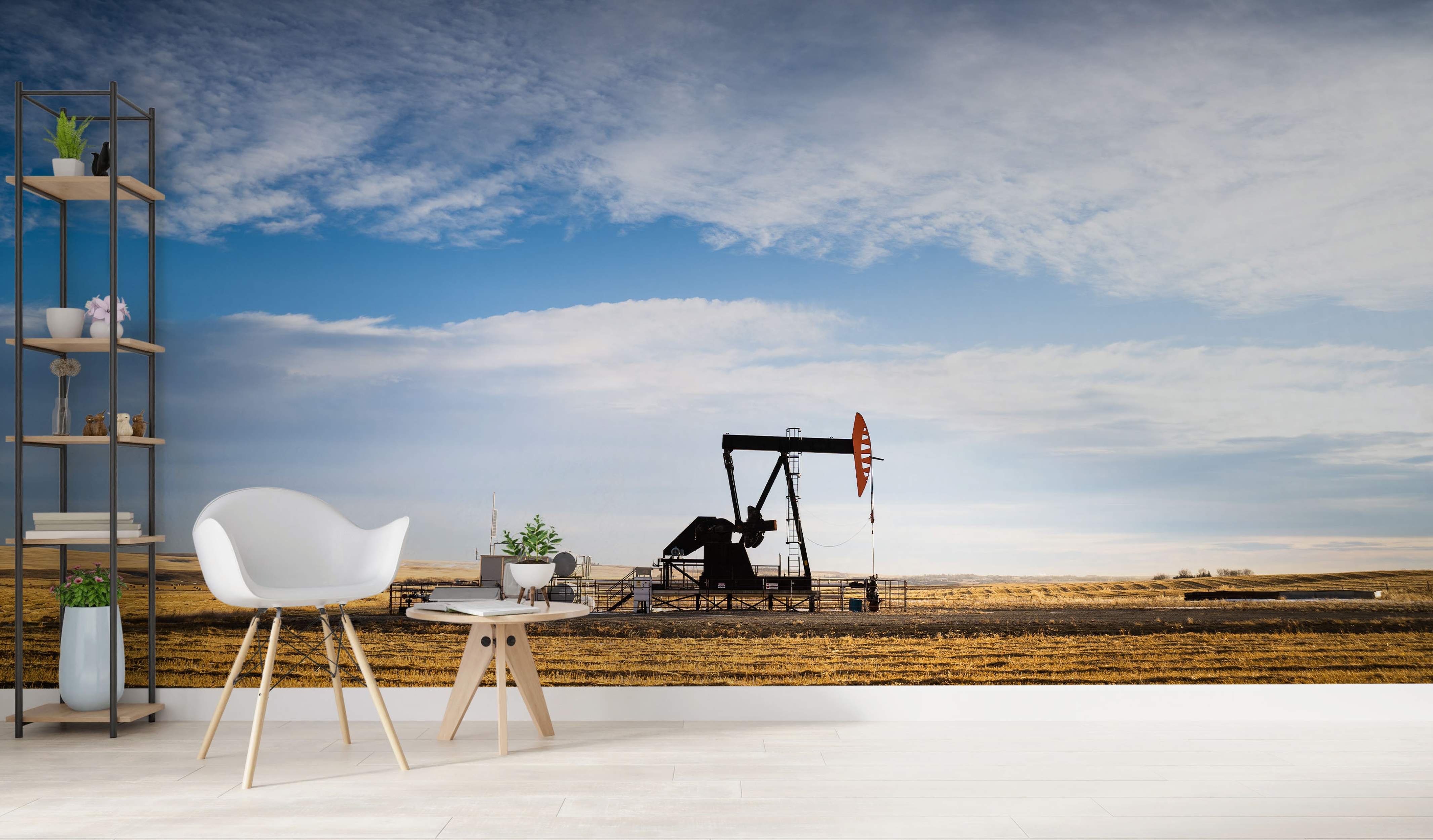 Photorealistic mural depicting a black oil pump jack silhouette in a golden field under a wide blue sky with wispy clouds.
