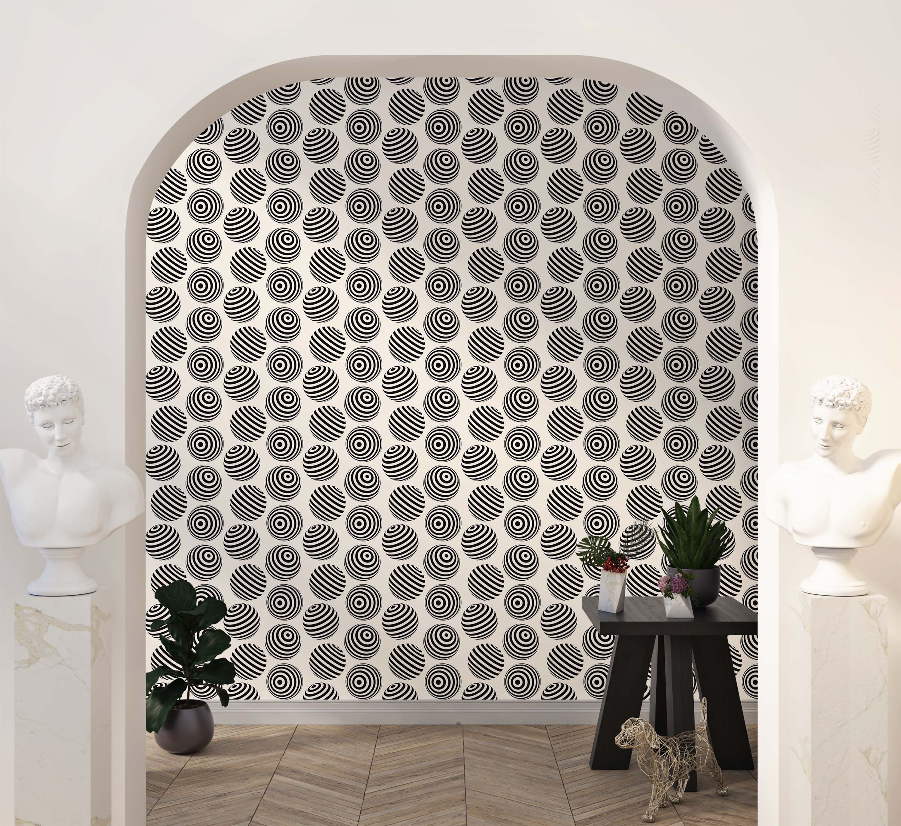 Op art wallpaper featuring repeating black and white circles with concentric rings and stripes on a cream background.