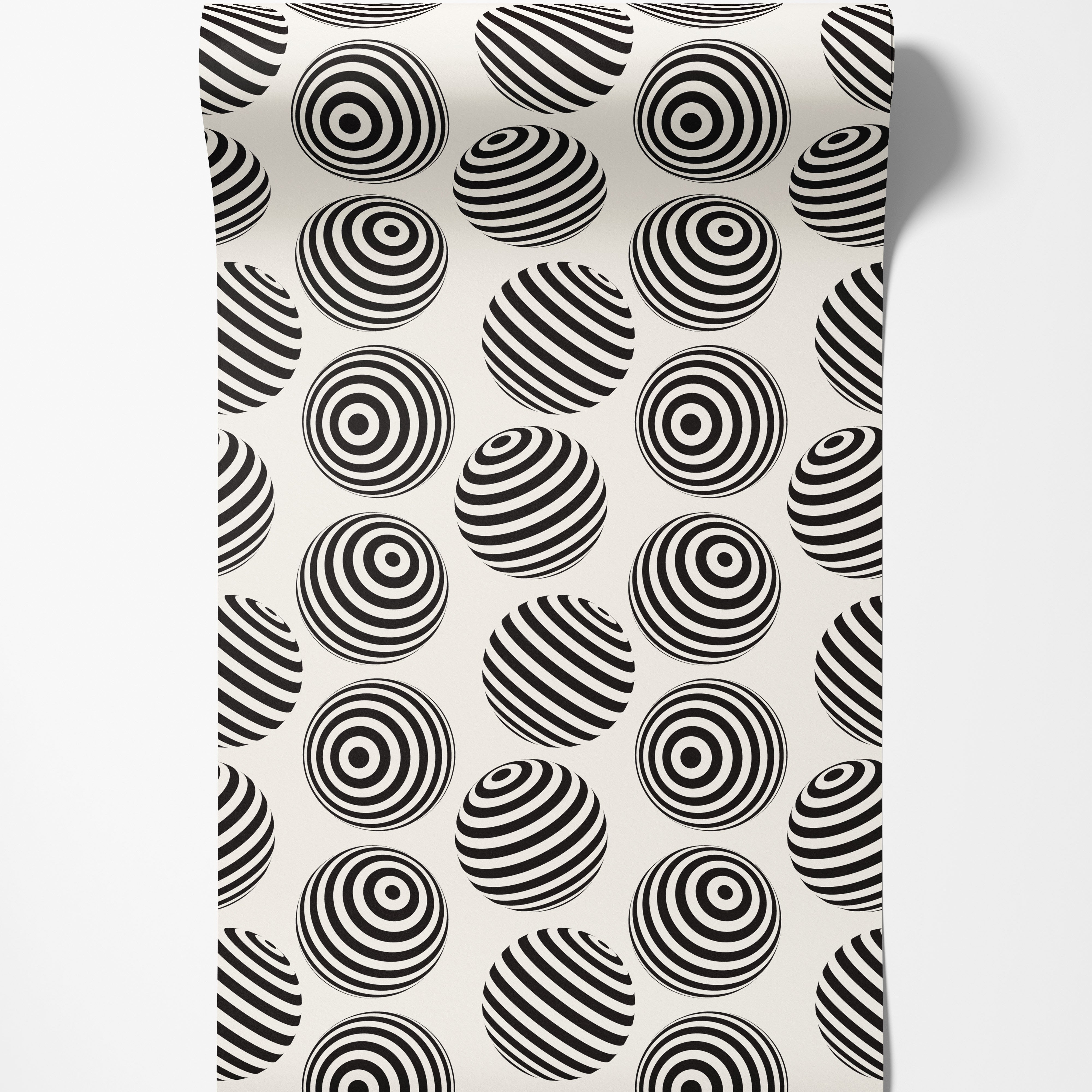 Wallpaper with an op-art pattern of black and off-white spheres, detailed with concentric rings or diagonal stripes.