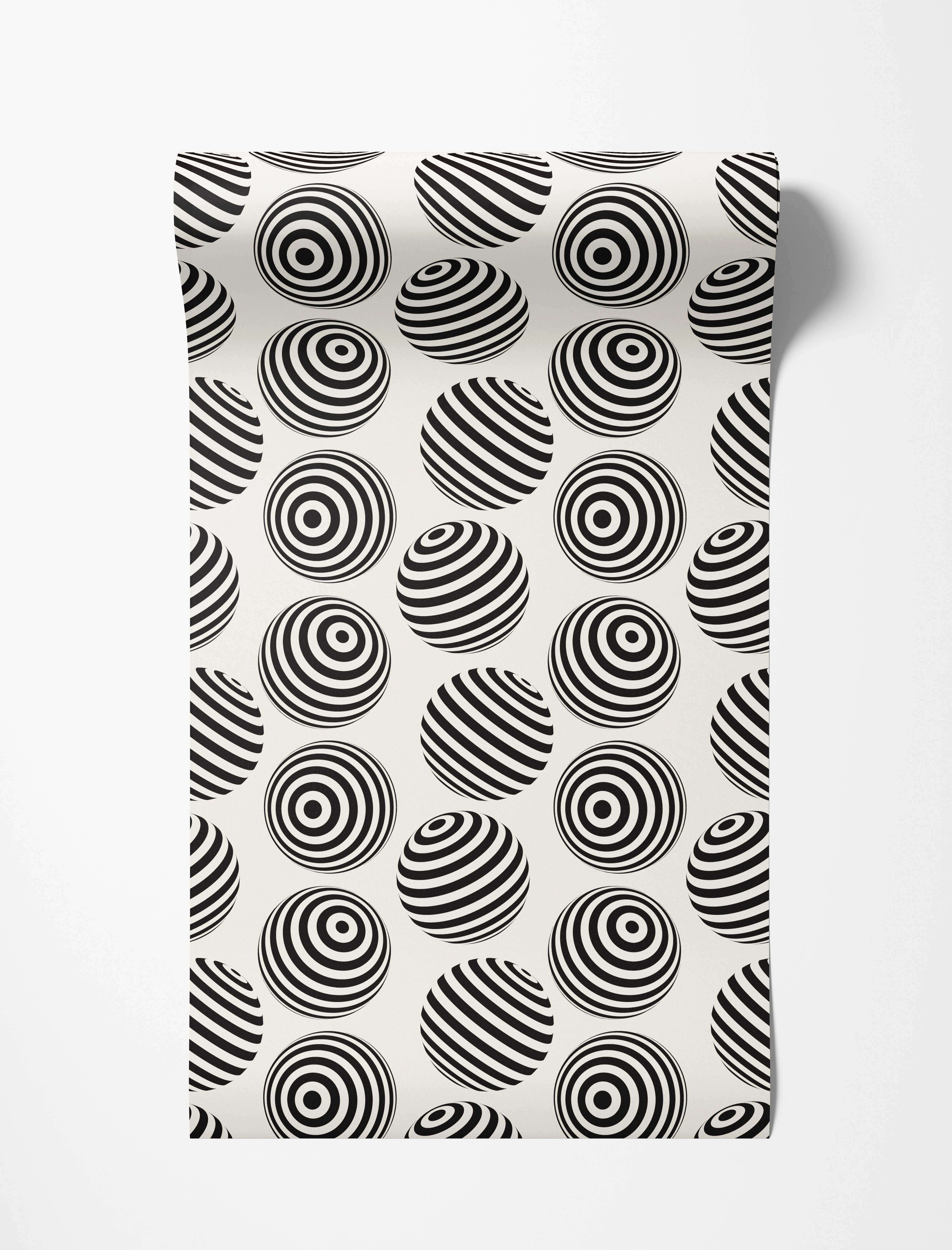 Wallpaper with an op-art pattern of black and off-white spheres, detailed with concentric rings or diagonal stripes.