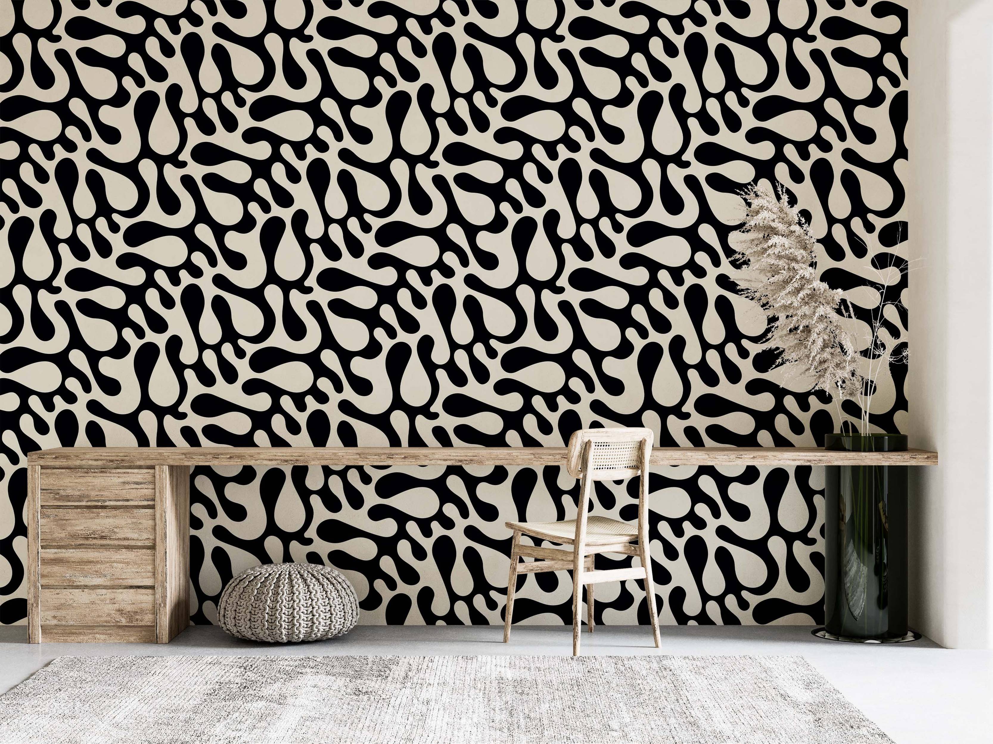Wallpaper featuring a repeating pattern of large, abstract black organic blob shapes on a cream background.