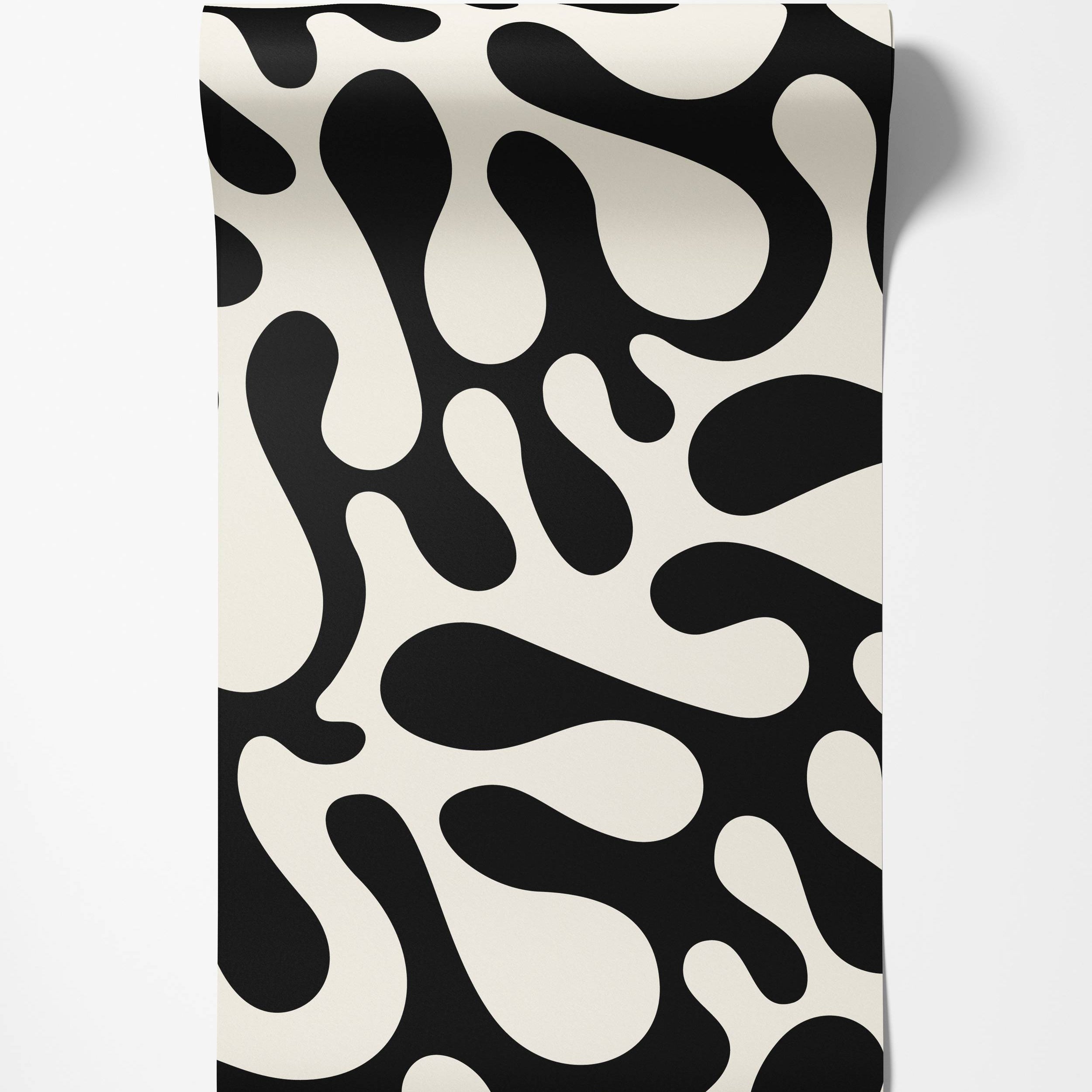 Wallpaper featuring a bold pattern of large, irregular black organic shapes on an off-white background.