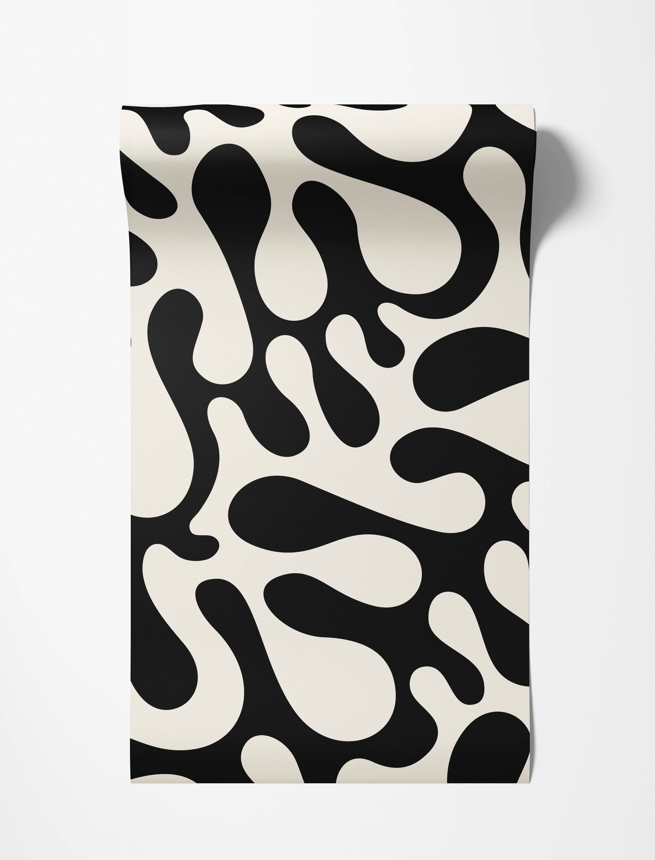 Wallpaper featuring a bold pattern of large, irregular black organic shapes on an off-white background.