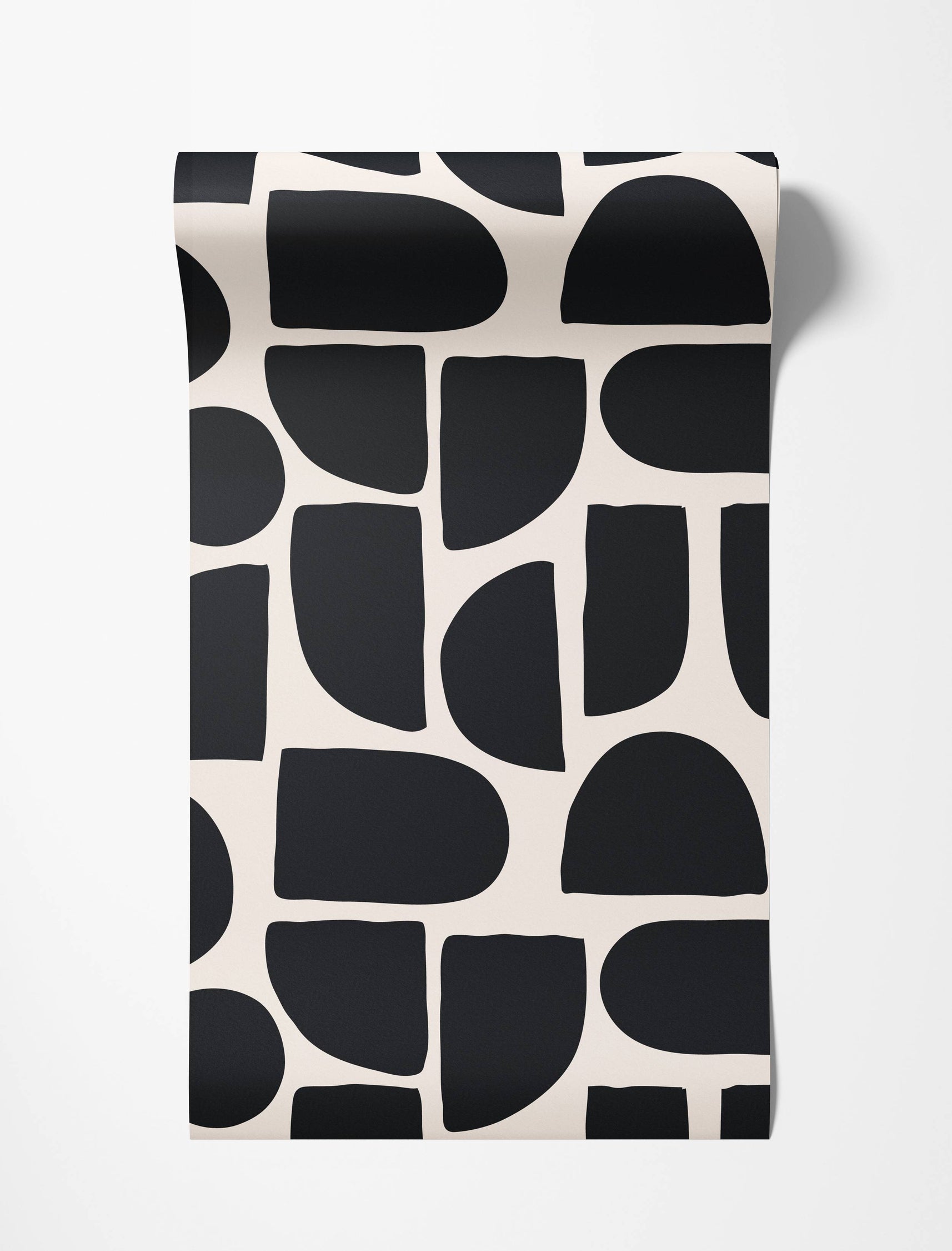 Bold abstract wallpaper featuring large, rounded geometric shapes in black against a cream background.