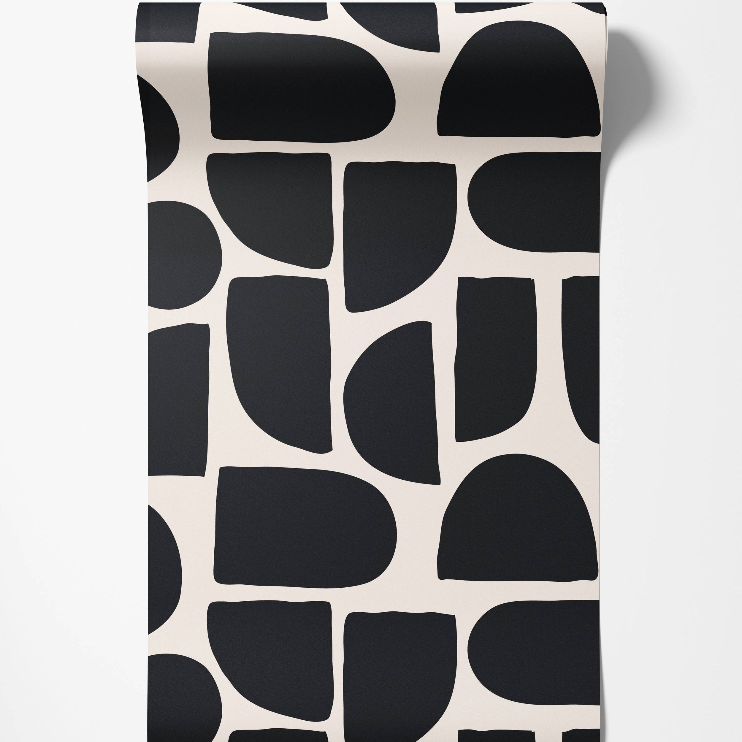 Bold abstract wallpaper featuring large, rounded geometric shapes in black against a cream background.