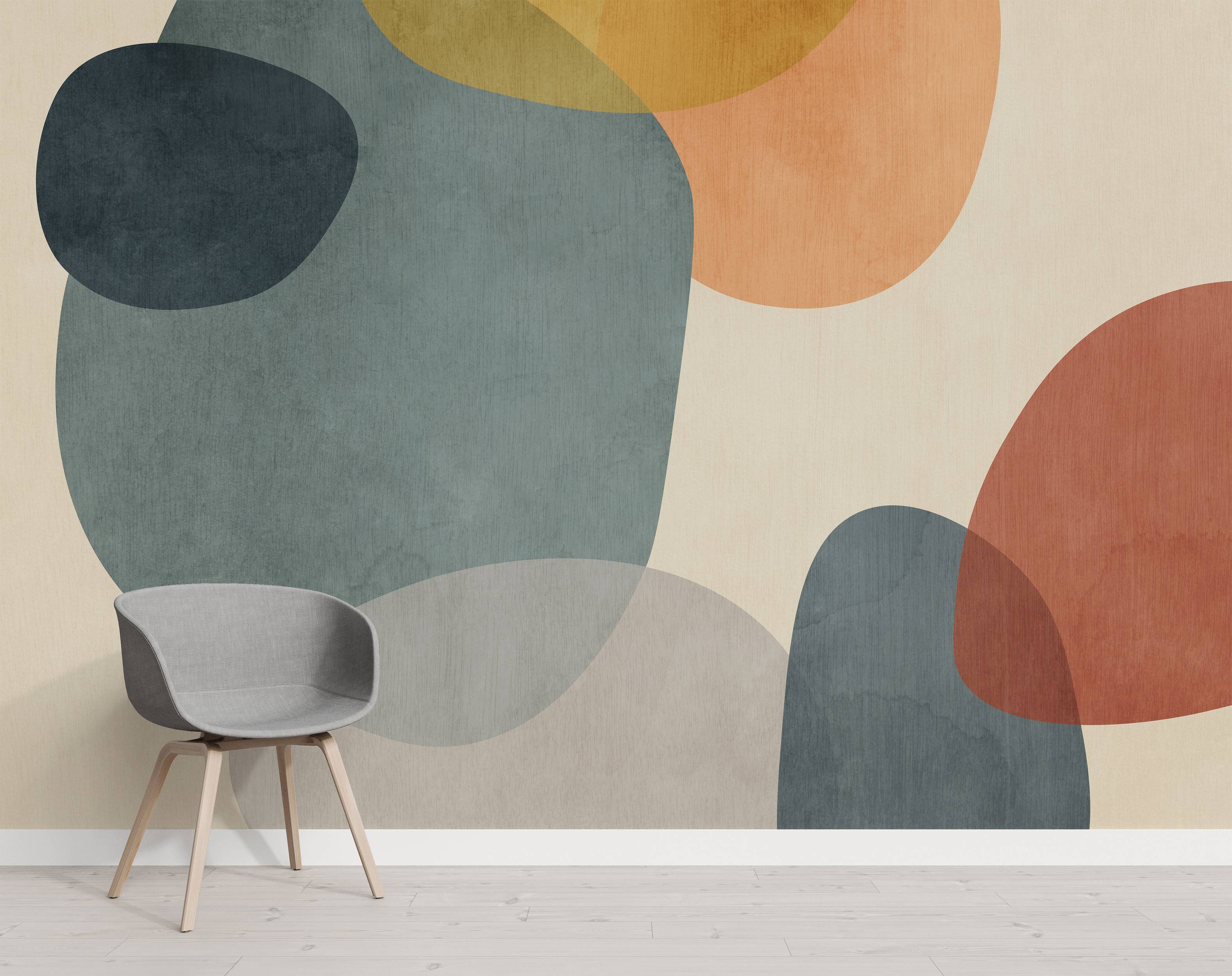 Mural with large, overlapping organic shapes in muted teal, orange, yellow, and beige, exhibiting a subtle textured finish.