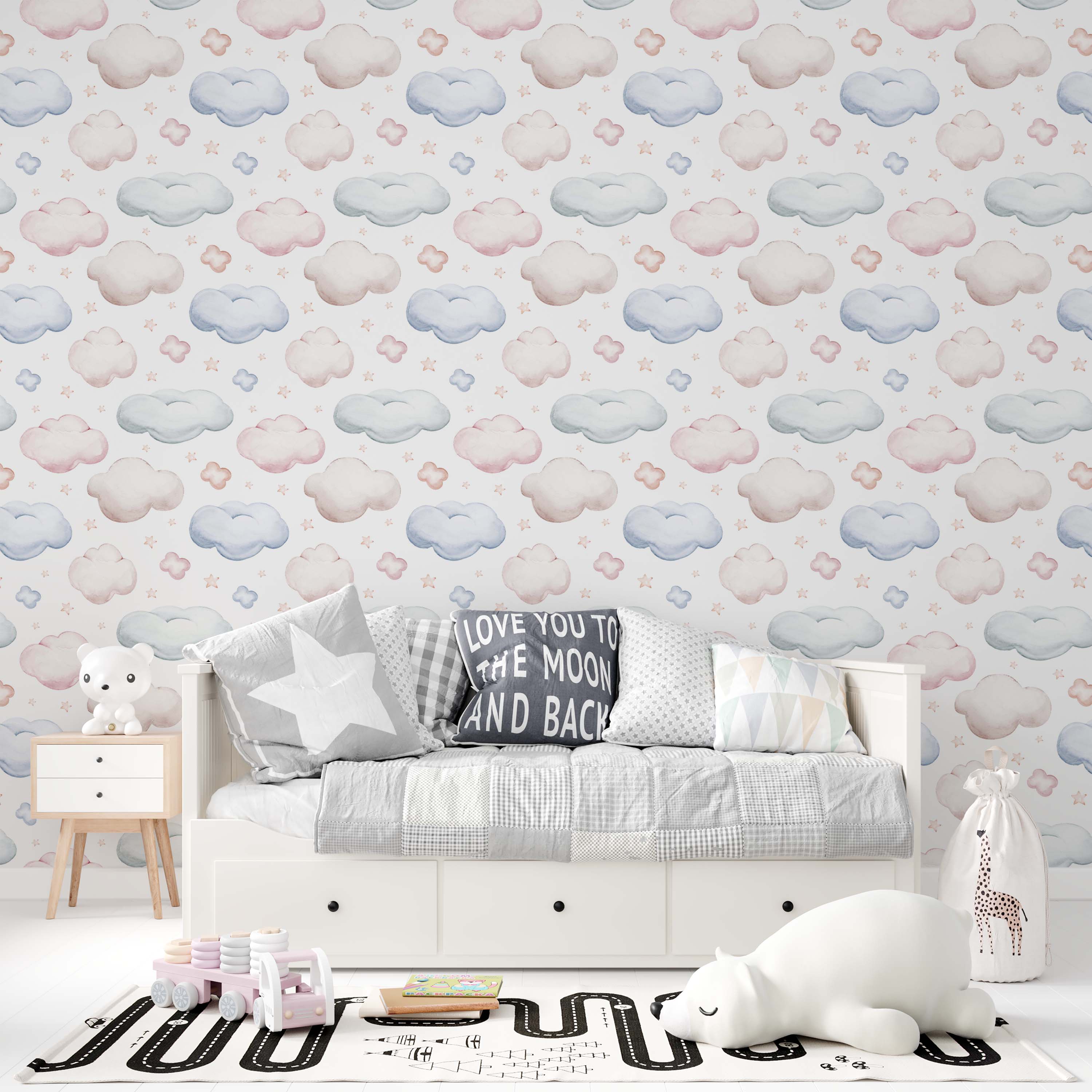 Wallpaper with a whimsical pattern of pastel pink, blue, and beige watercolor clouds, smaller cloud puffs, and stars on white.