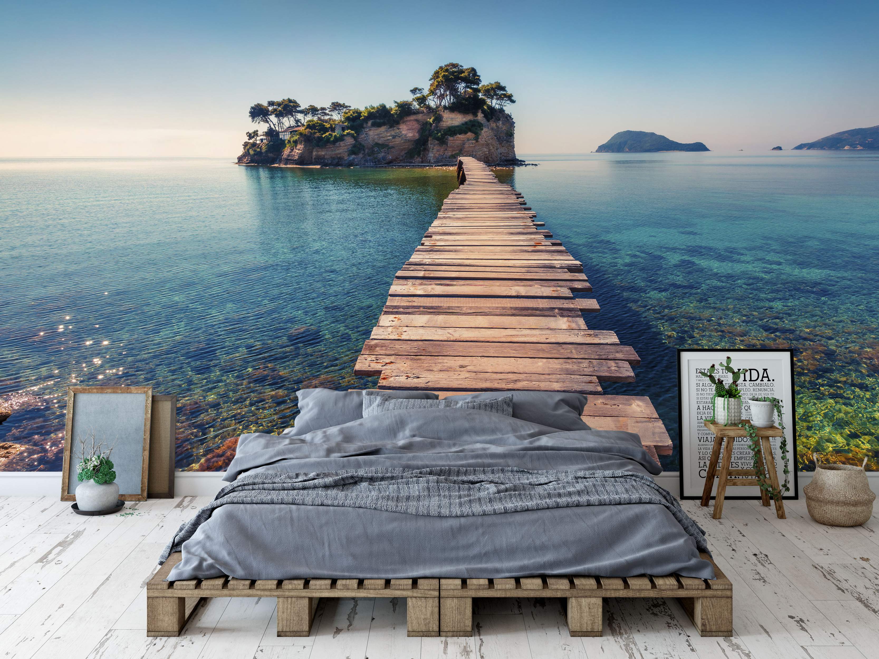 Photorealistic mural featuring a wooden pier leading to a small, green island in calm, clear turquoise water under a bright blue sky.
