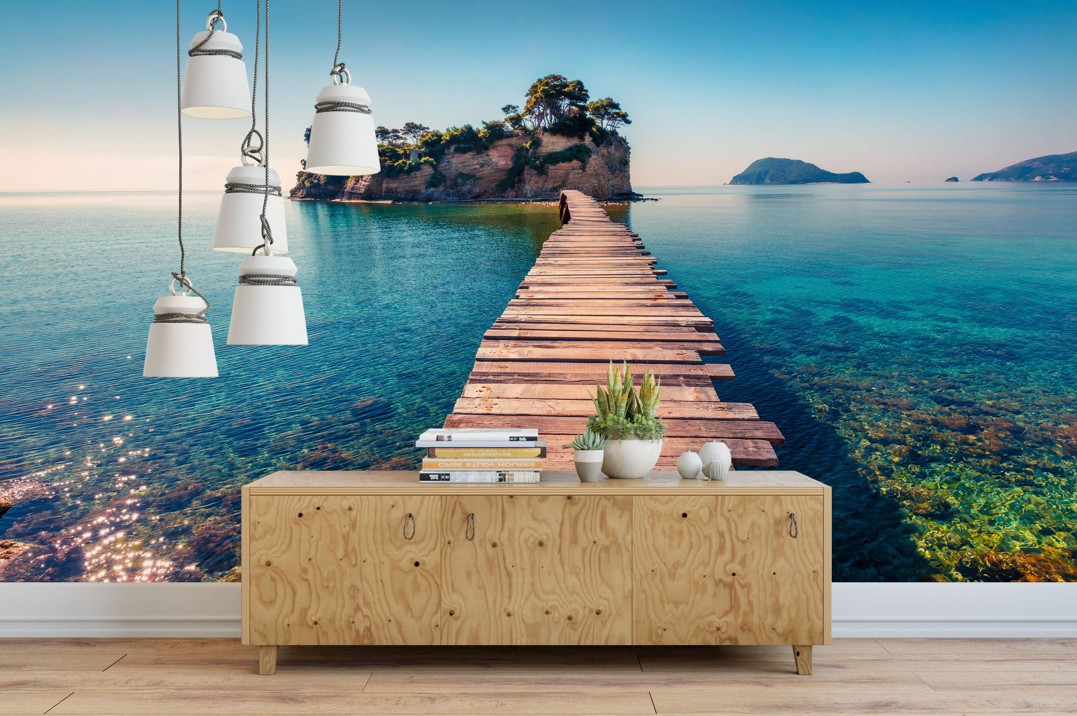 Scenic mural depicting a wooden pier leading across clear turquoise water to a small, rocky island under a blue sky.