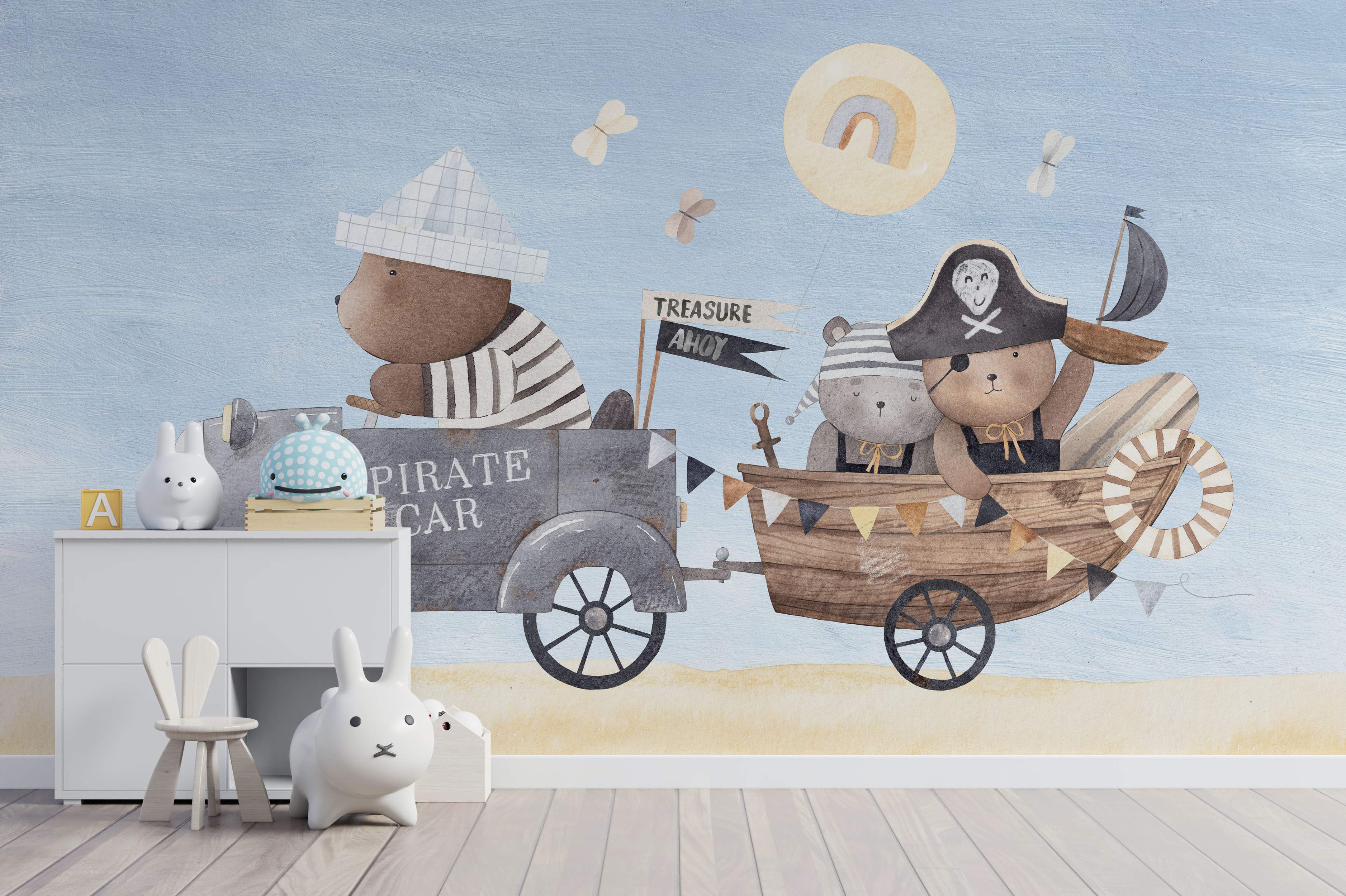 Kids' wall mural showing watercolor pirate bears in a car towing a boat, set on a beach with a blue sky and sun.