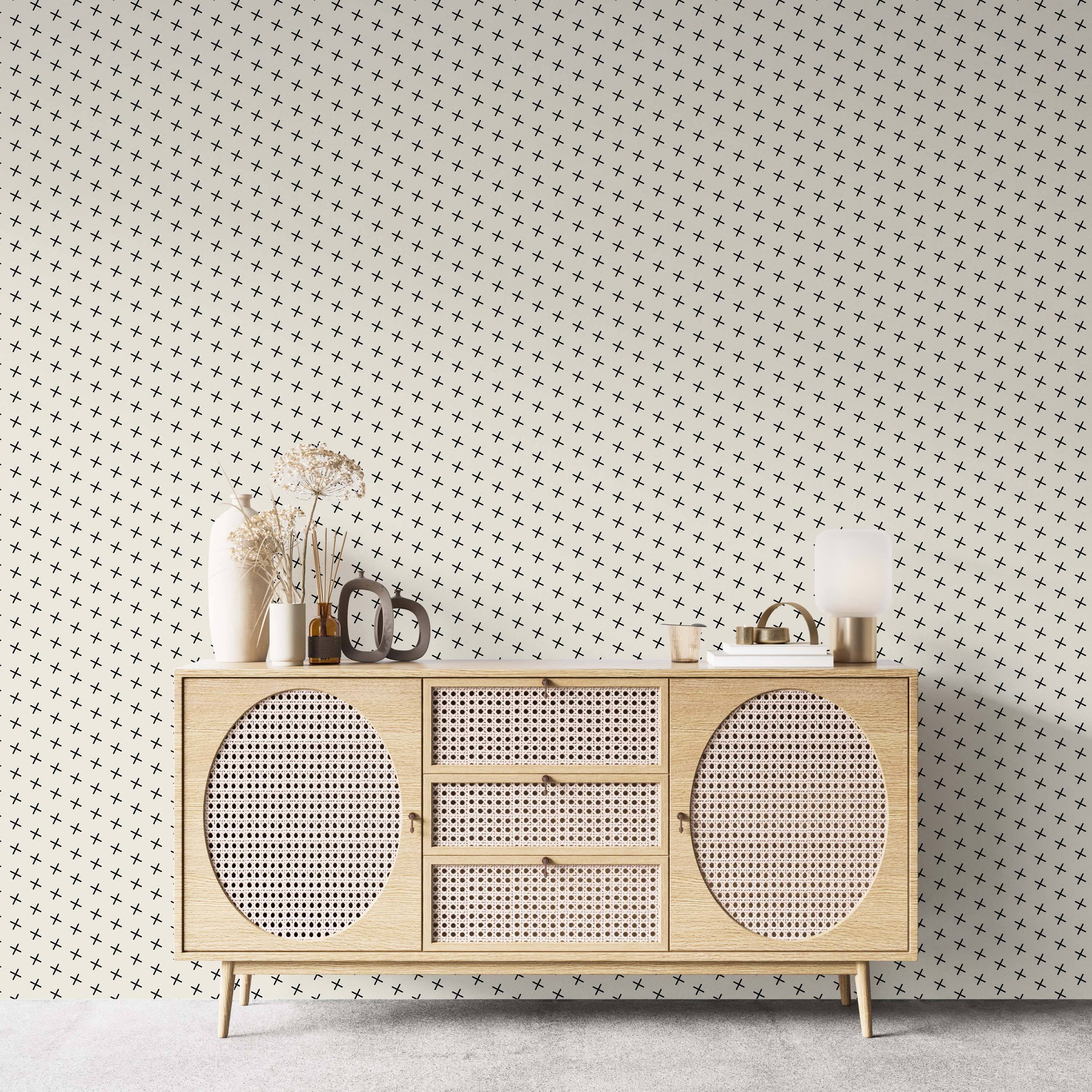 Wallpaper featuring a pattern of small black plus signs arranged diagonally on a light cream background.