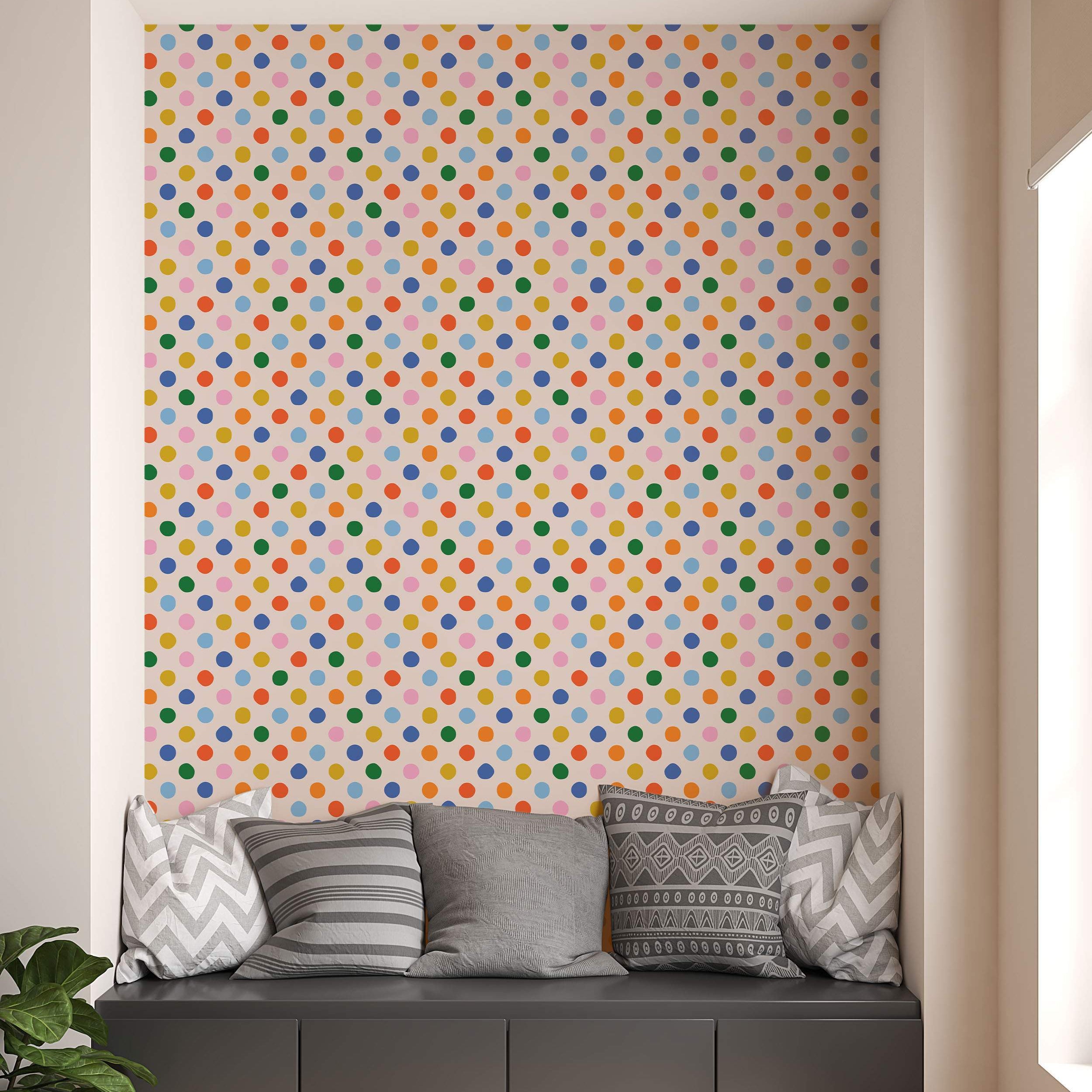 Wallpaper featuring a repeating pattern of multicolor polka dots in red, orange, yellow, green, blue, and pink on a light background.