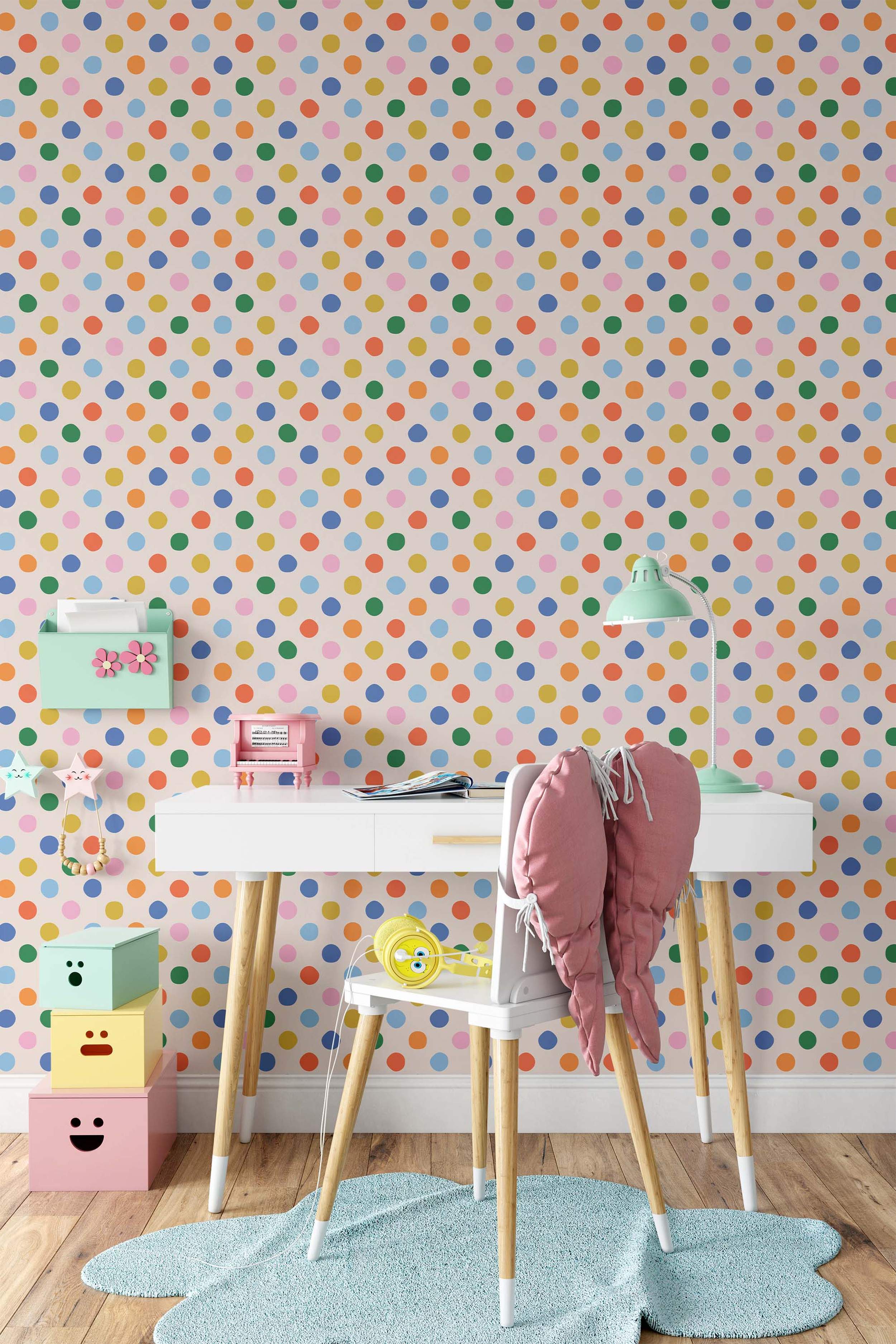 Wallpaper with a repeating pattern of multicolor polka dots including blue, green, yellow, orange, and pink on a light cream background.