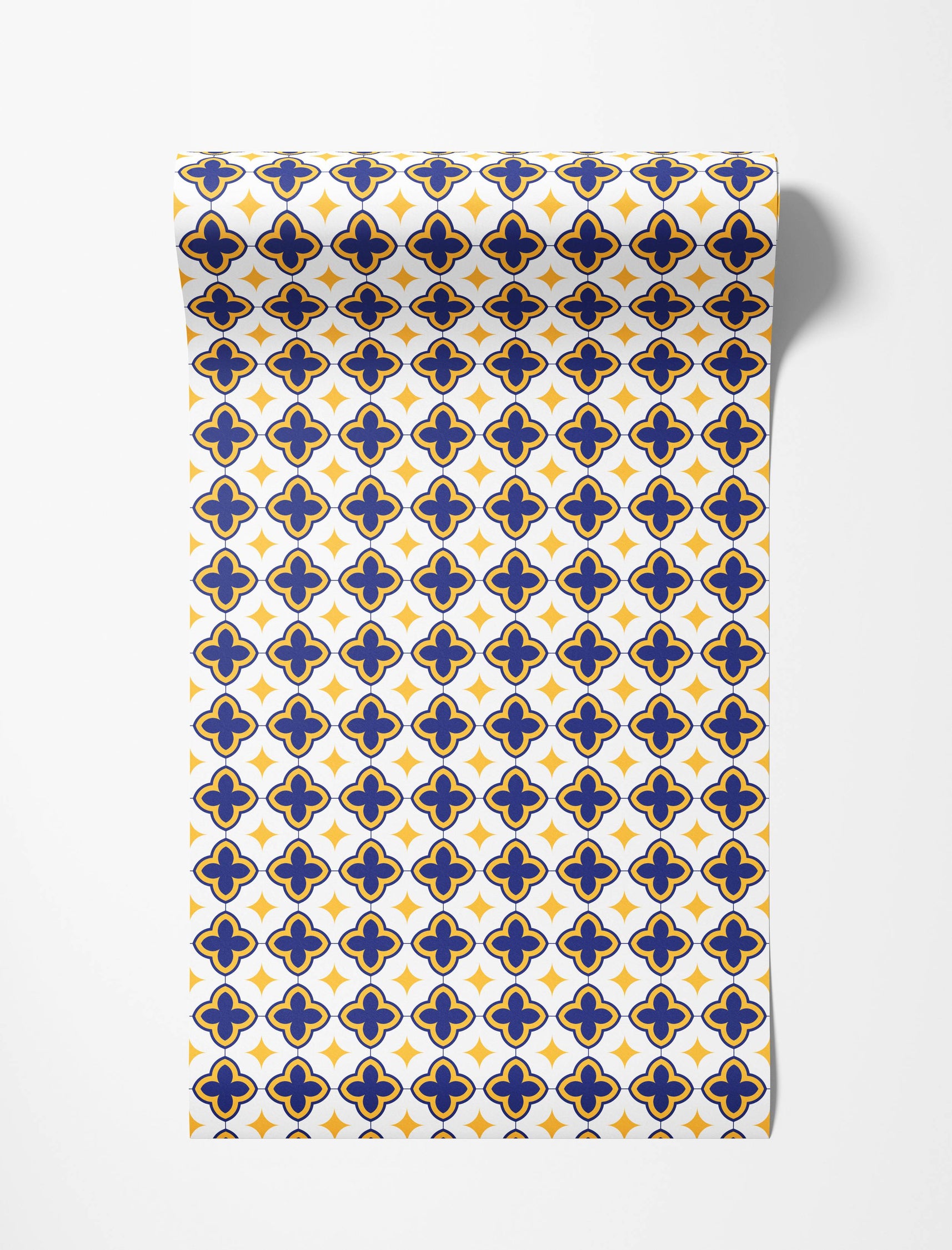 Geometric wallpaper with a pattern of blue and yellow quatrefoils and yellow diamonds on a white background.