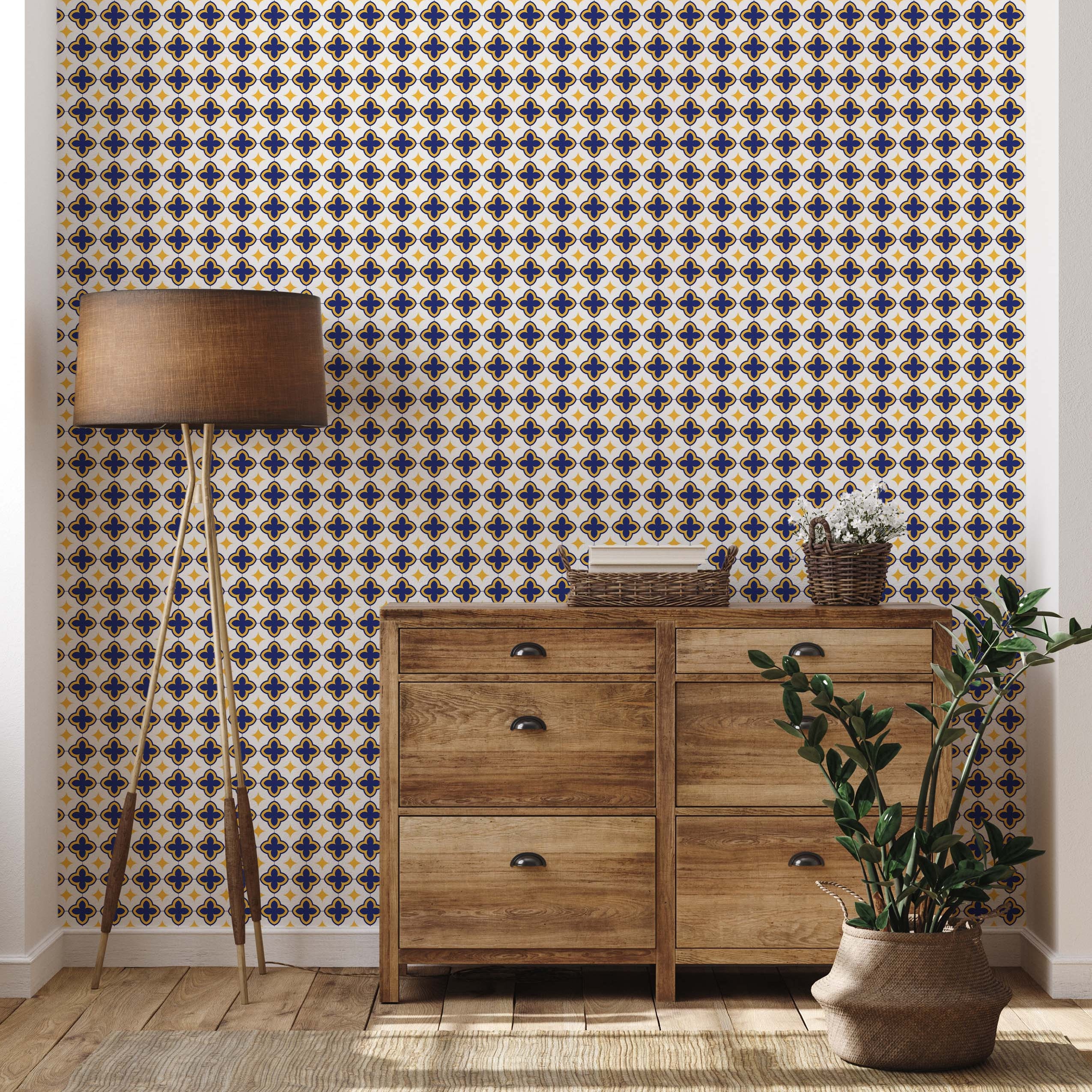 Wallpaper with a repeating geometric tile pattern of blue quatrefoils and yellow diamonds on a white background.