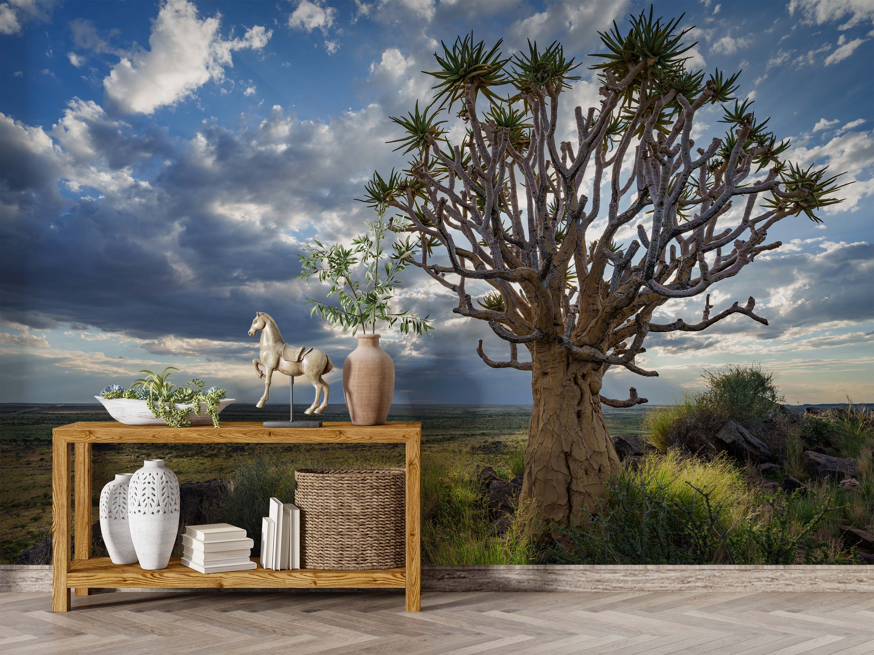 Mural of a large Quiver tree in a savanna landscape under a dramatic, cloudy sky with sunbeams.