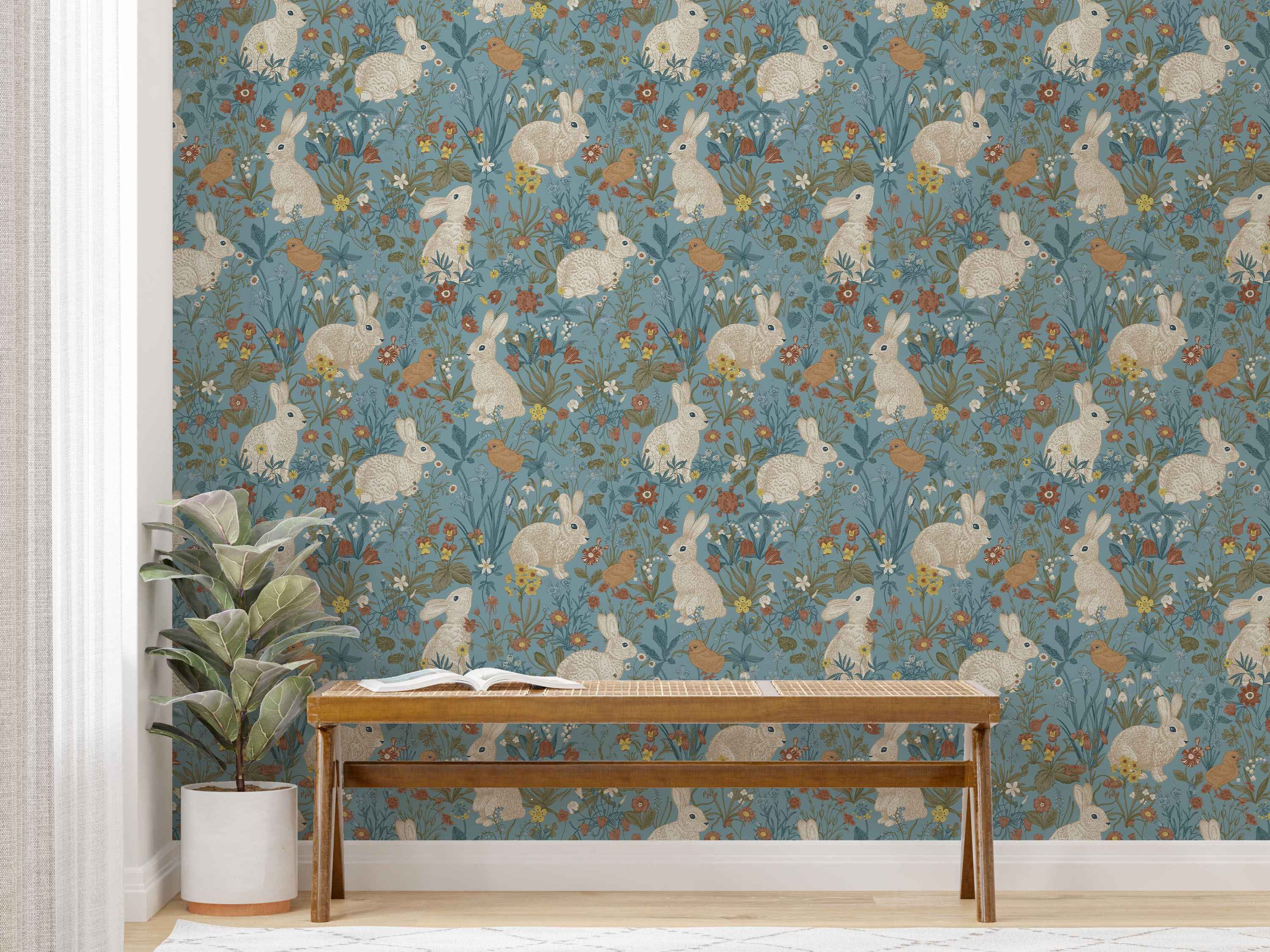 Whimsical wallpaper featuring illustrated white rabbits and brown birds among colorful flowers and green foliage on a muted blue background.