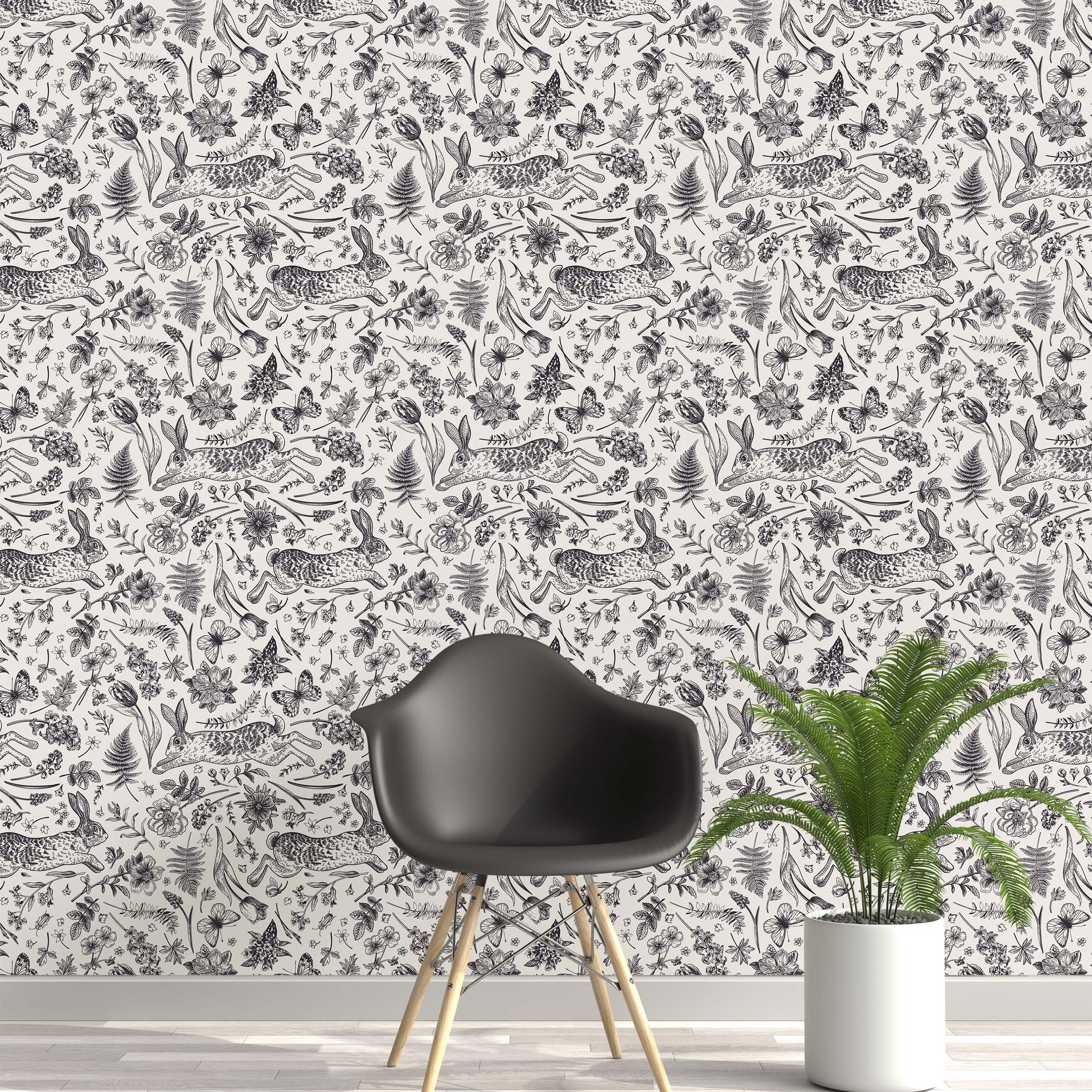 Monochrome wallpaper with a detailed, hand-drawn pattern of leaping rabbits, flowers, butterflies, and ferns on a cream background.