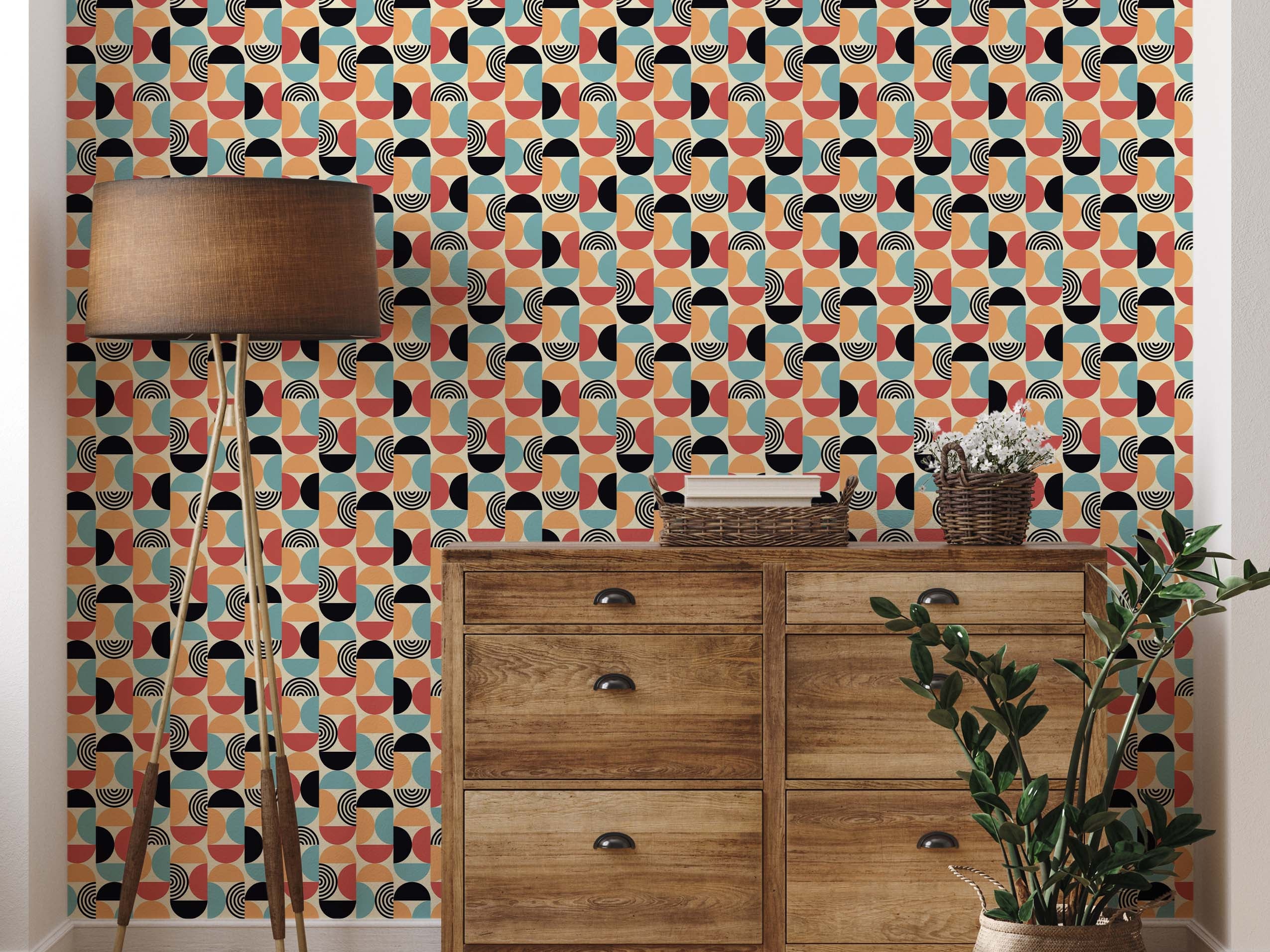 Retro geometric wallpaper featuring a repeating pattern of ovals composed of red-orange, teal, black, and cream semicircles with line details.