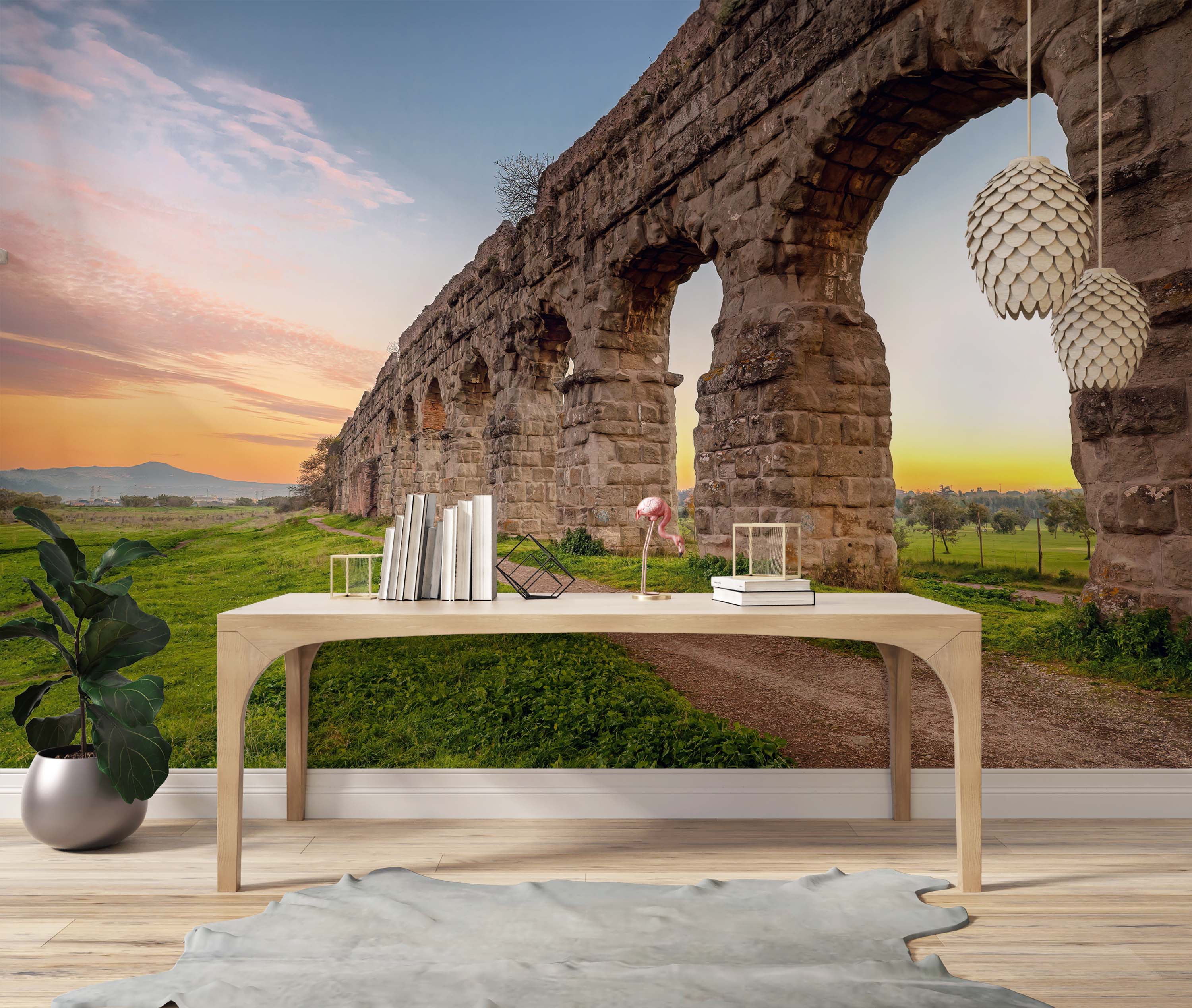 A scenic wall mural depicting a stone Roman aqueduct in a green field under a vibrant sunrise sky.