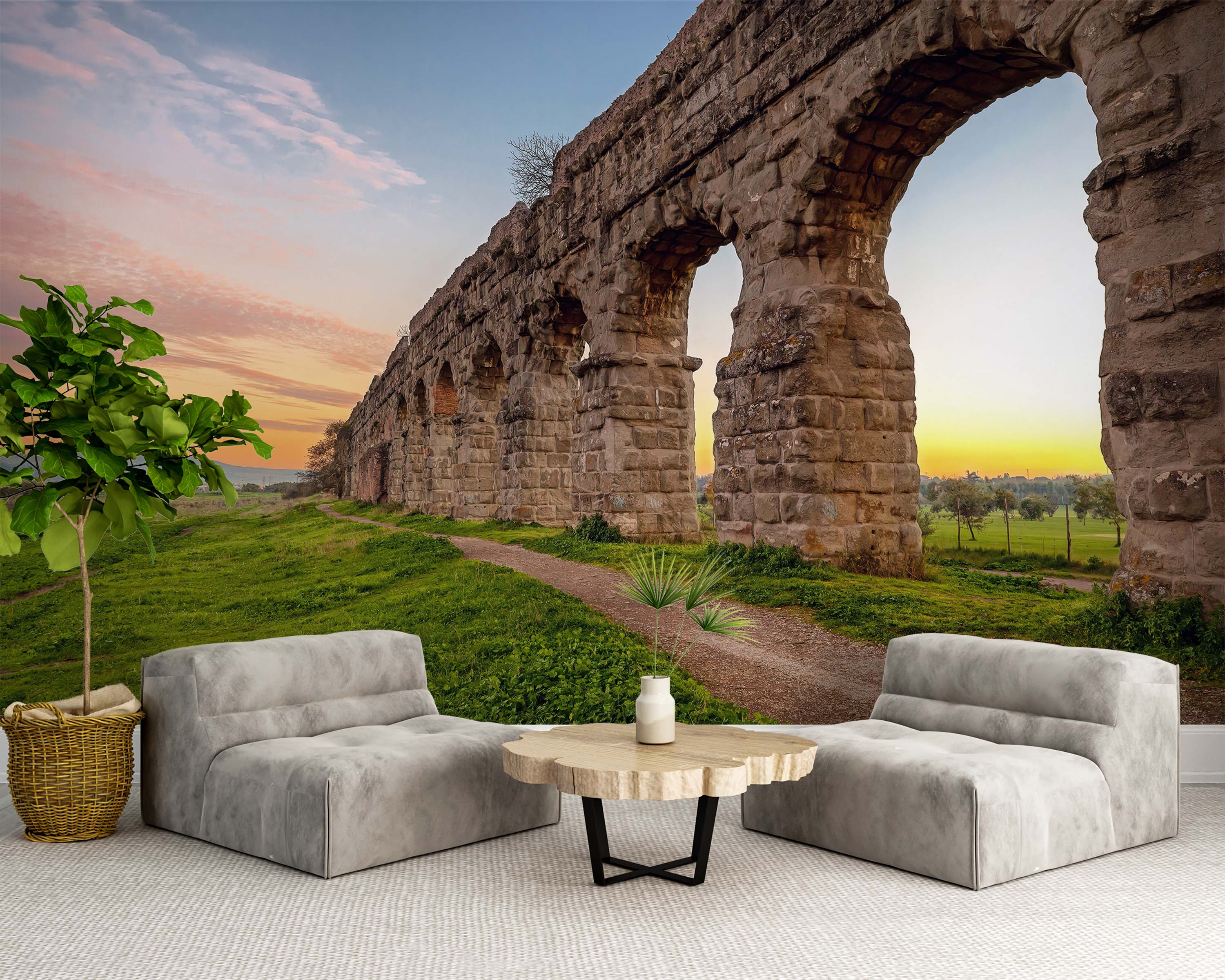 A scenic mural of ancient Roman aqueduct ruins in a green field under a colorful sunset sky.