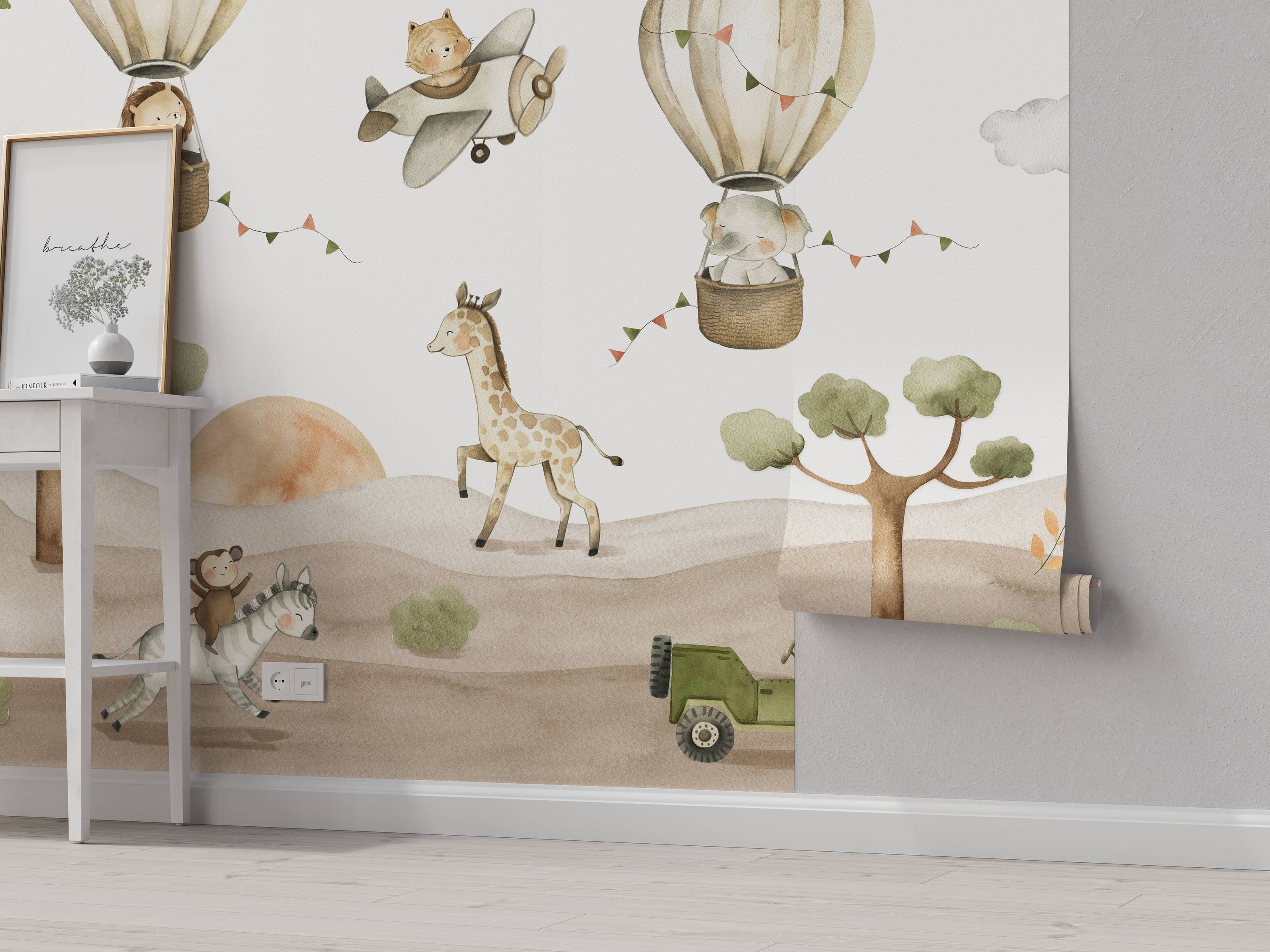 Watercolor mural depicting a whimsical safari scene with animals, hot air balloons, and an airplane in soft, earthy tones.