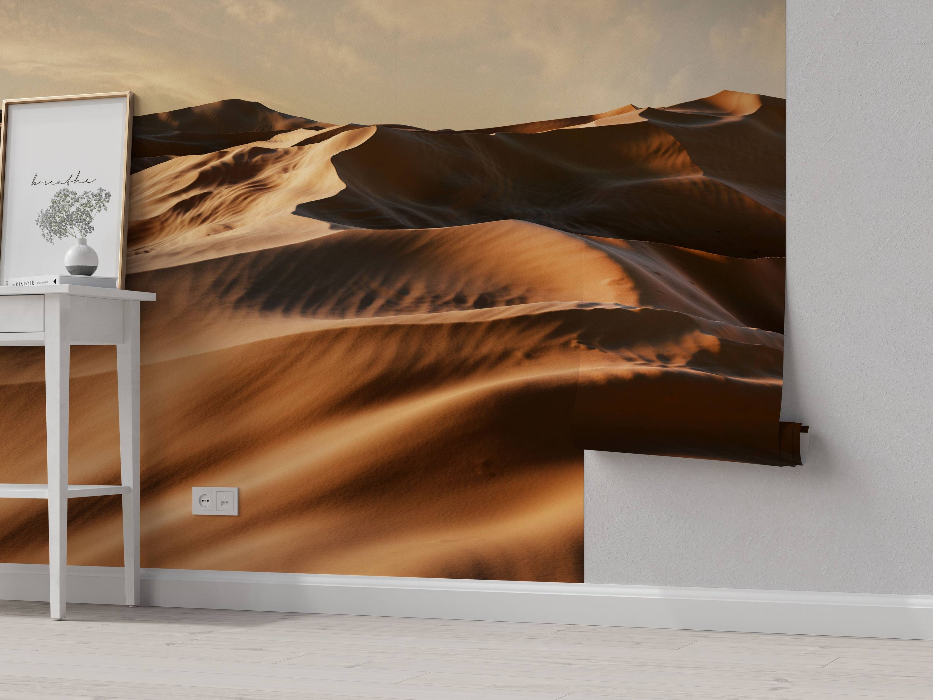 A photorealistic wall mural of vast desert sand dunes under a warm, golden sky at sunset, creating a serene landscape.