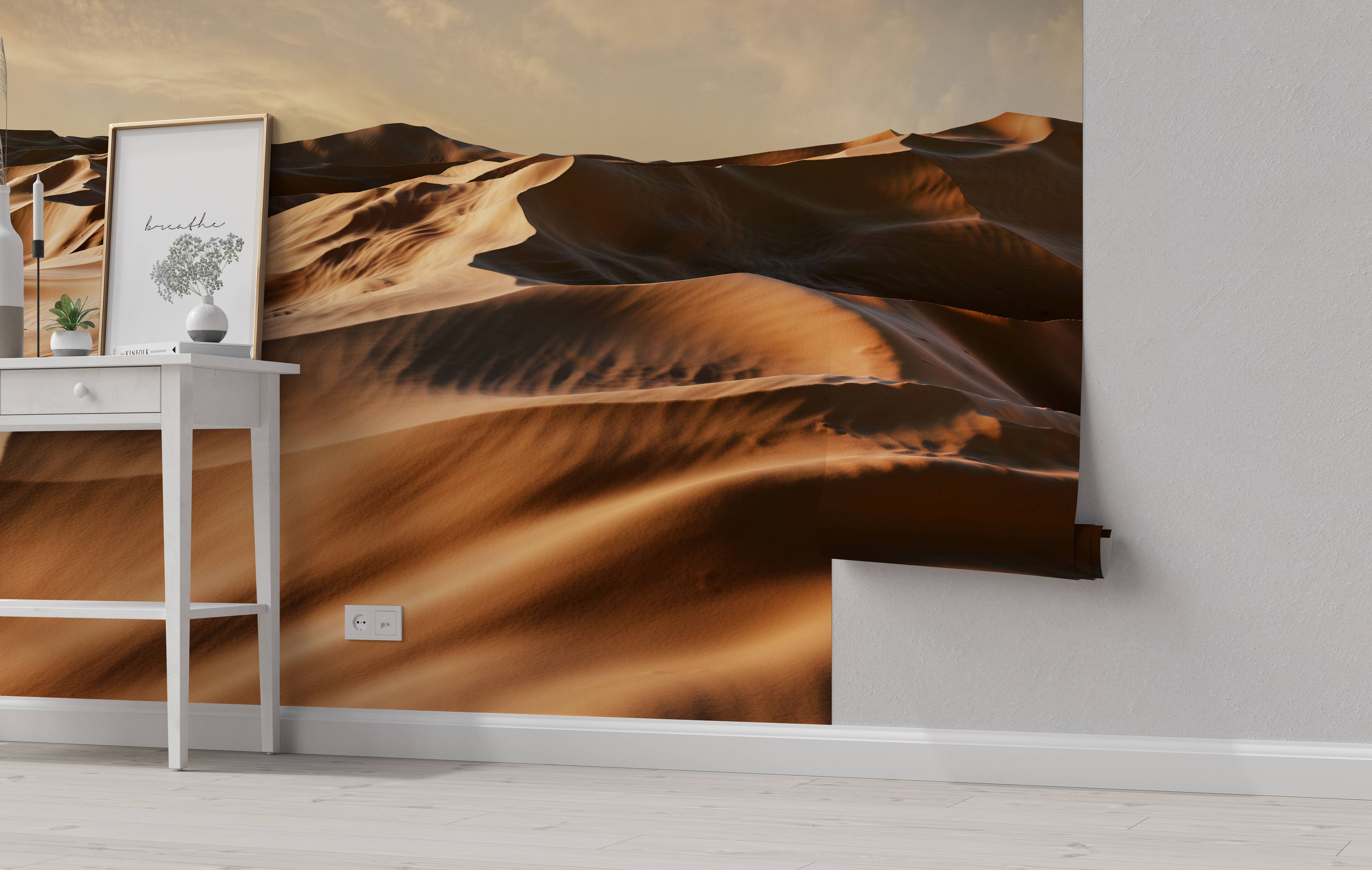 A photorealistic wall mural of vast desert sand dunes under a warm, golden sky at sunset, creating a serene landscape.