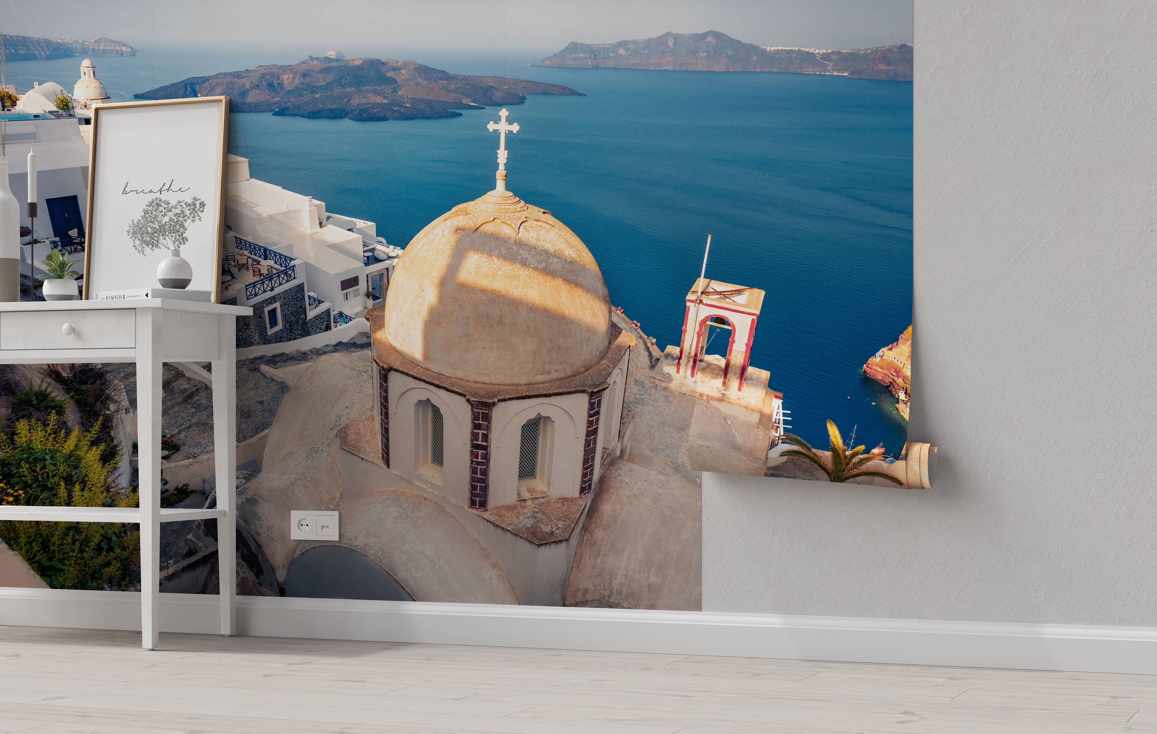 A scenic wall mural of Santorini, featuring a sunlit church dome overlooking the deep blue Aegean Sea and volcanic islands.