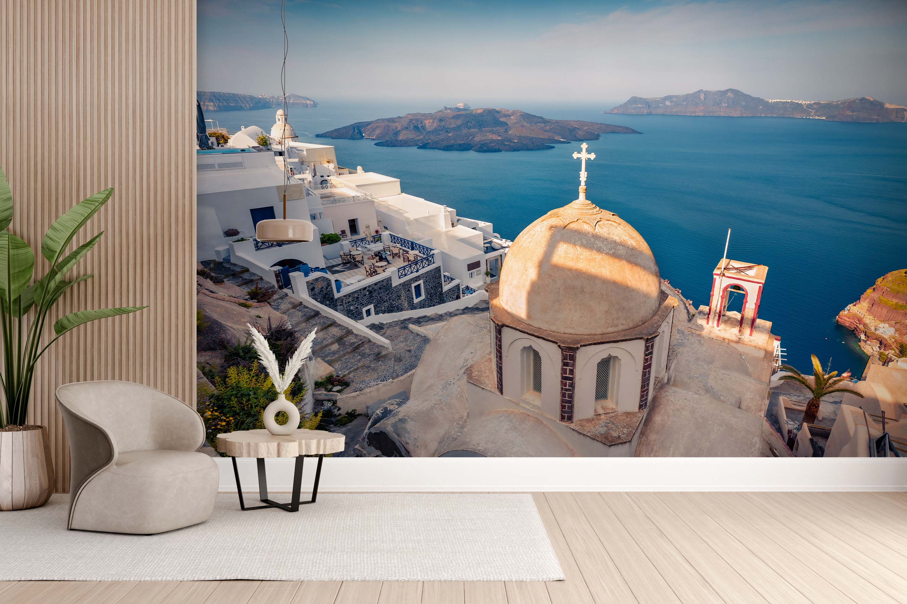 A scenic photographic mural of a Greek village in Santorini, featuring whitewashed buildings and a church dome by the blue sea.