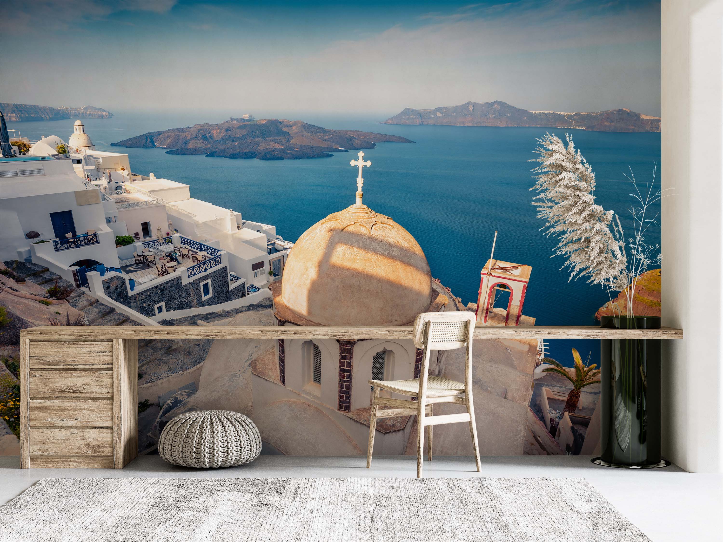 A scenic mural of Santorini, with white buildings and a church dome against a vibrant blue sea and sky.