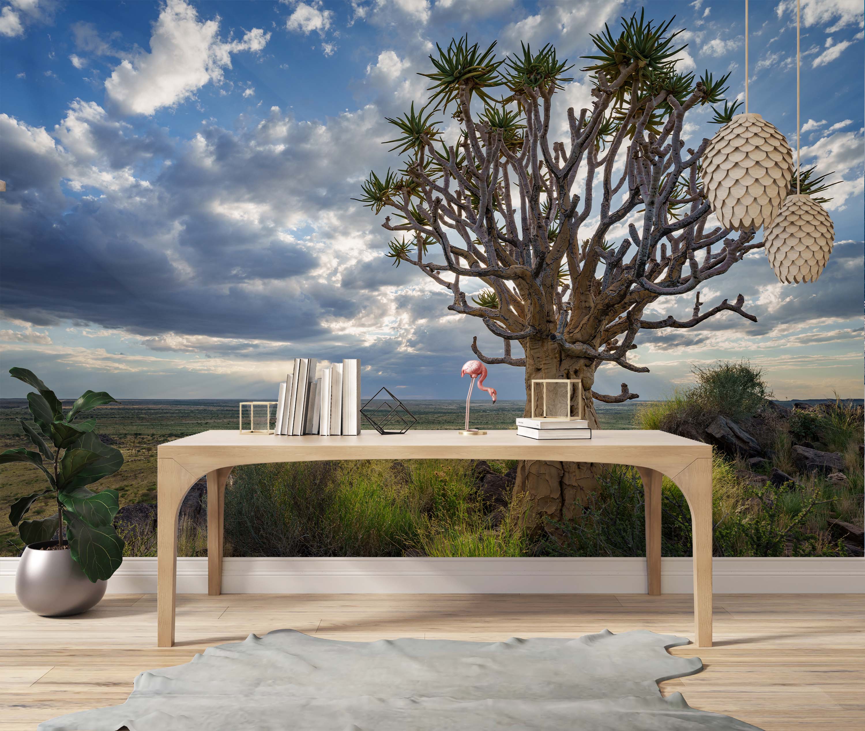 A photorealistic mural of a large Quiver Tree in a savanna landscape under a dramatic blue sky with white and grey clouds.