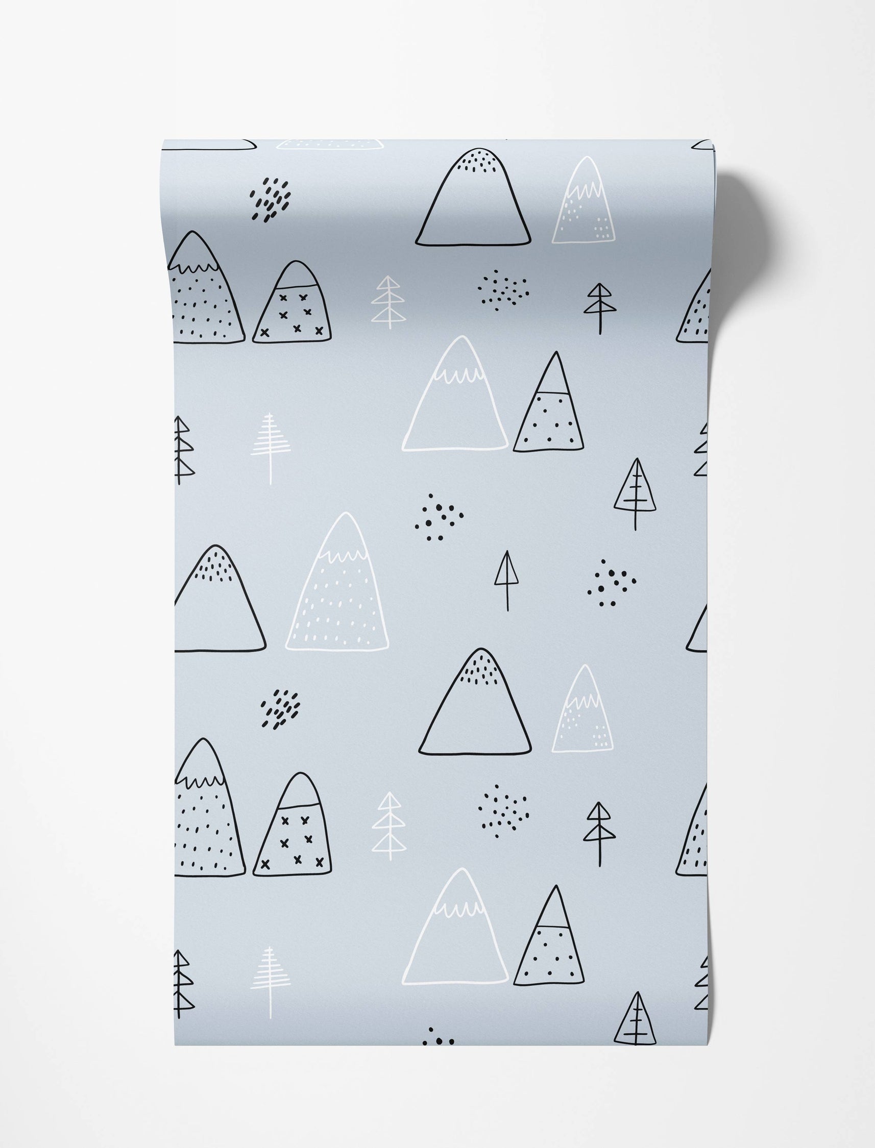 Scandinavian style wallpaper featuring a hand-drawn pattern of mountains and trees in black and white on a pale blue background.
