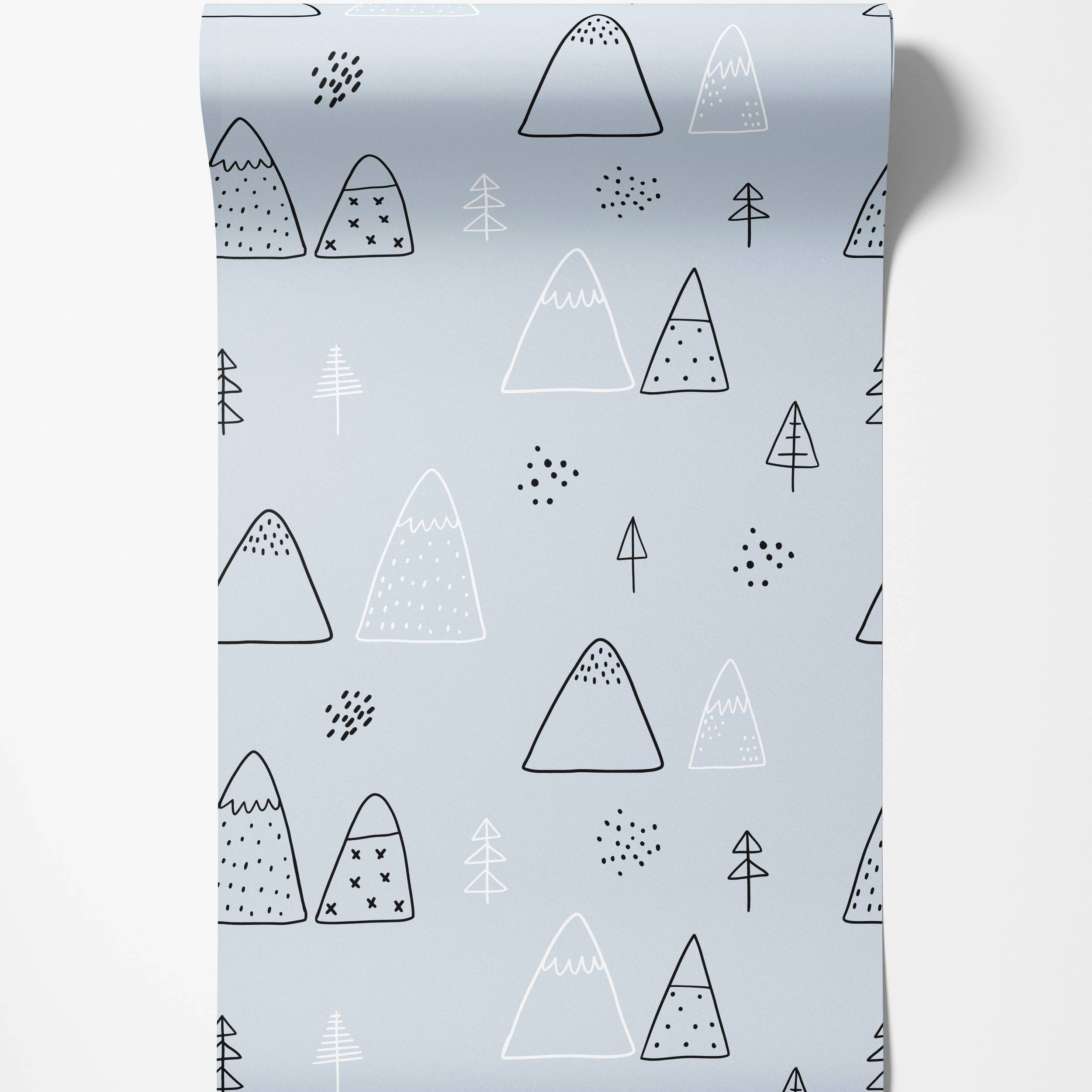Scandinavian style wallpaper featuring a hand-drawn pattern of mountains and trees in black and white on a pale blue background.
