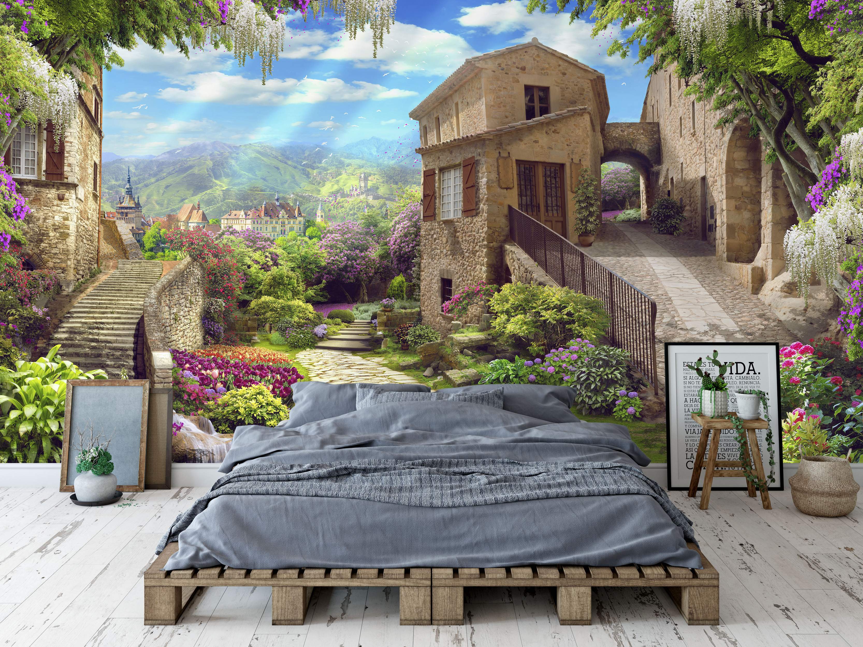 Scenic mural of a sunlit Italian village with stone buildings, cobblestone paths, stairs, vibrant flowers, and distant mountains.