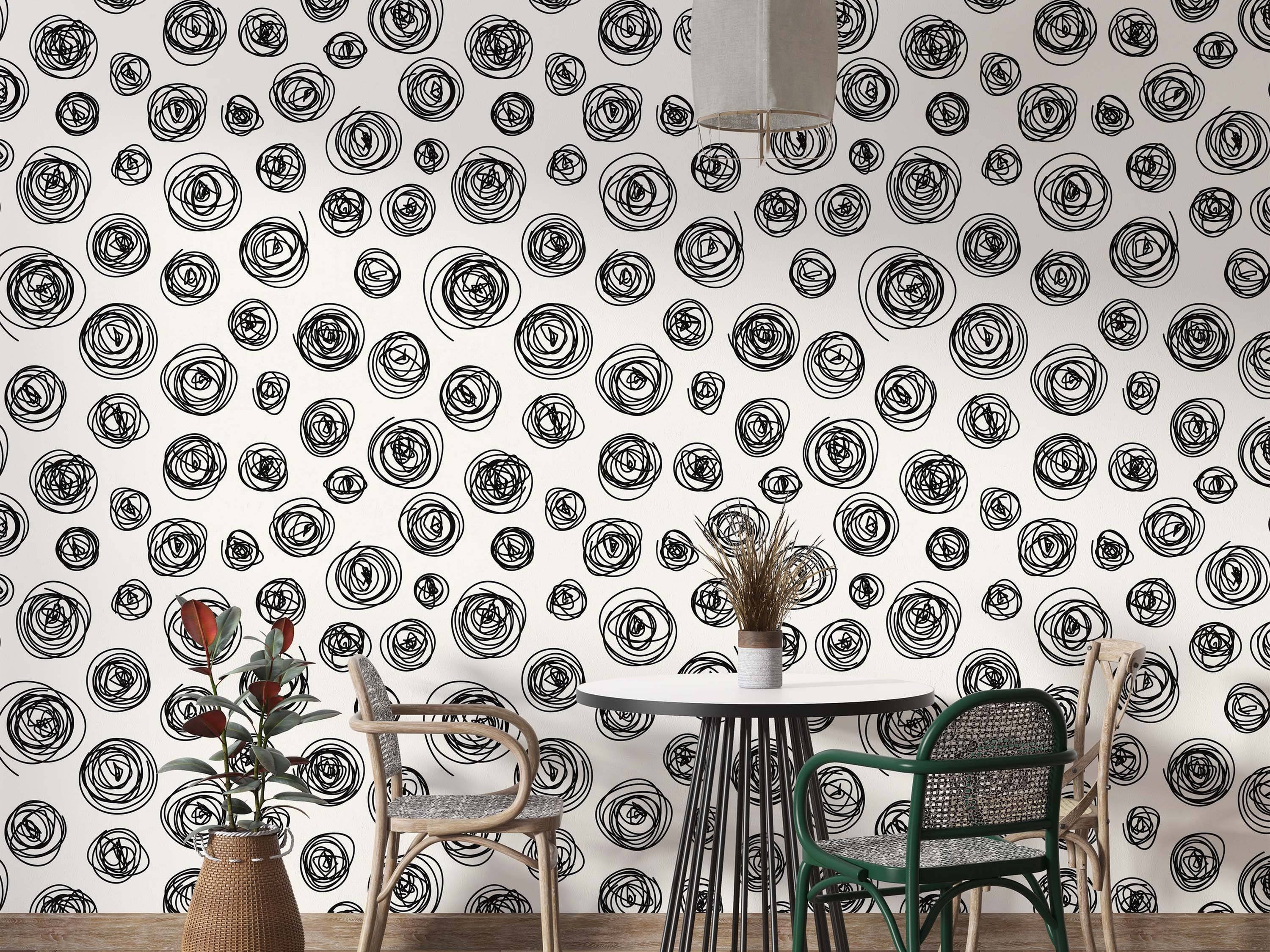 Wallpaper featuring a repeating pattern of hand-drawn black scribble circles on an off-white background.