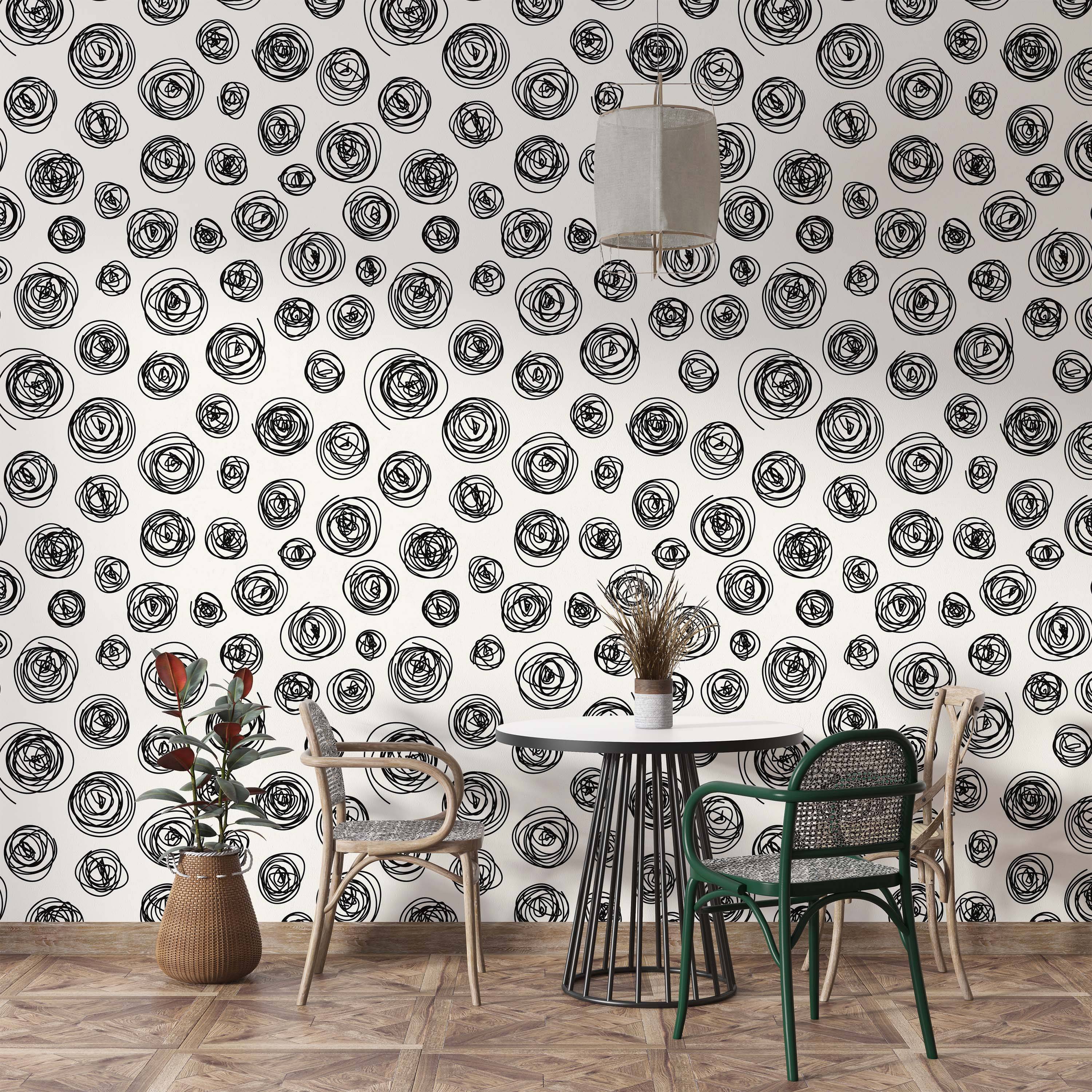Wallpaper featuring a repeating pattern of hand-drawn black scribble circles on an off-white background.