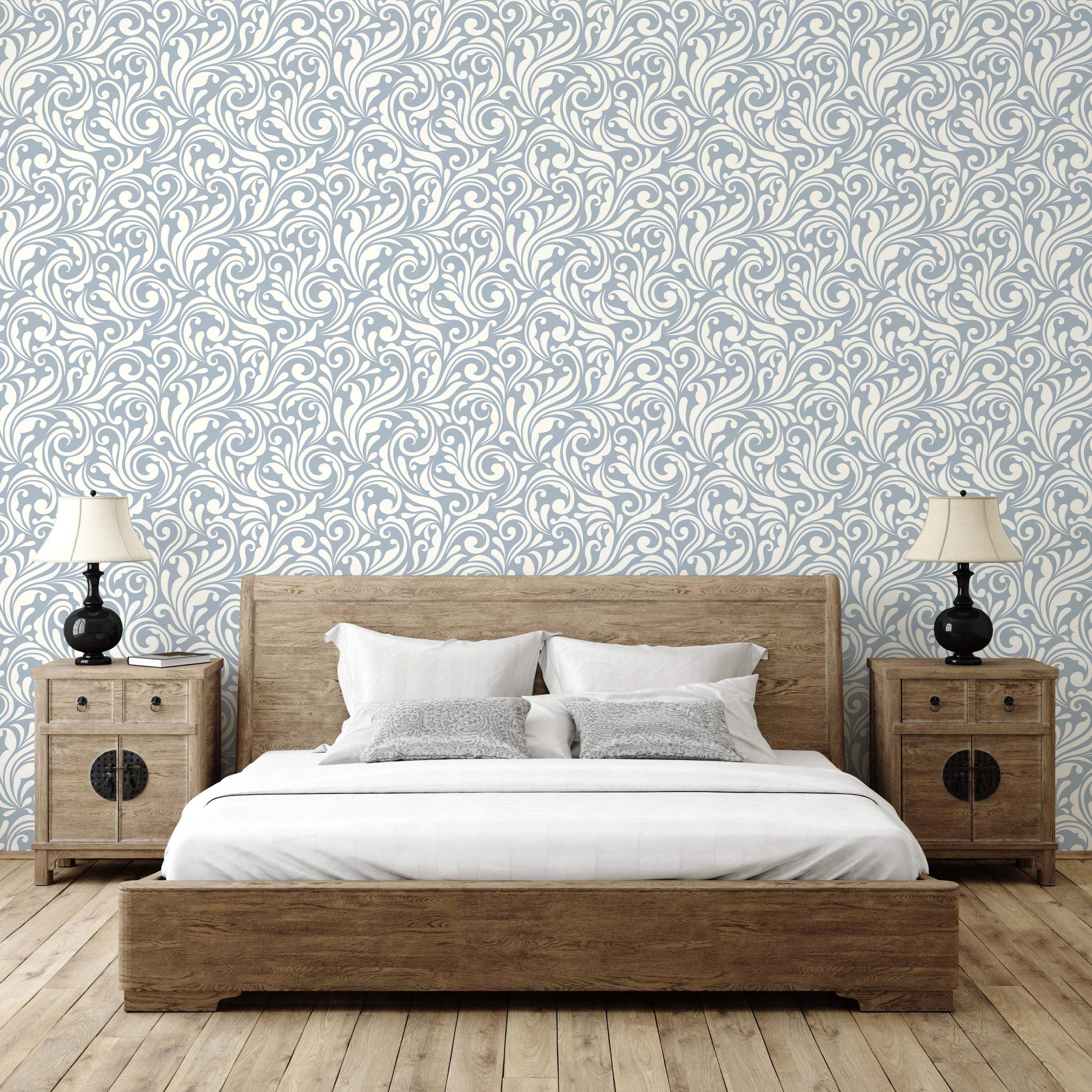 Wallpaper with an intricate pattern of cream-colored swirling vines and leaves on a pale blue ground.