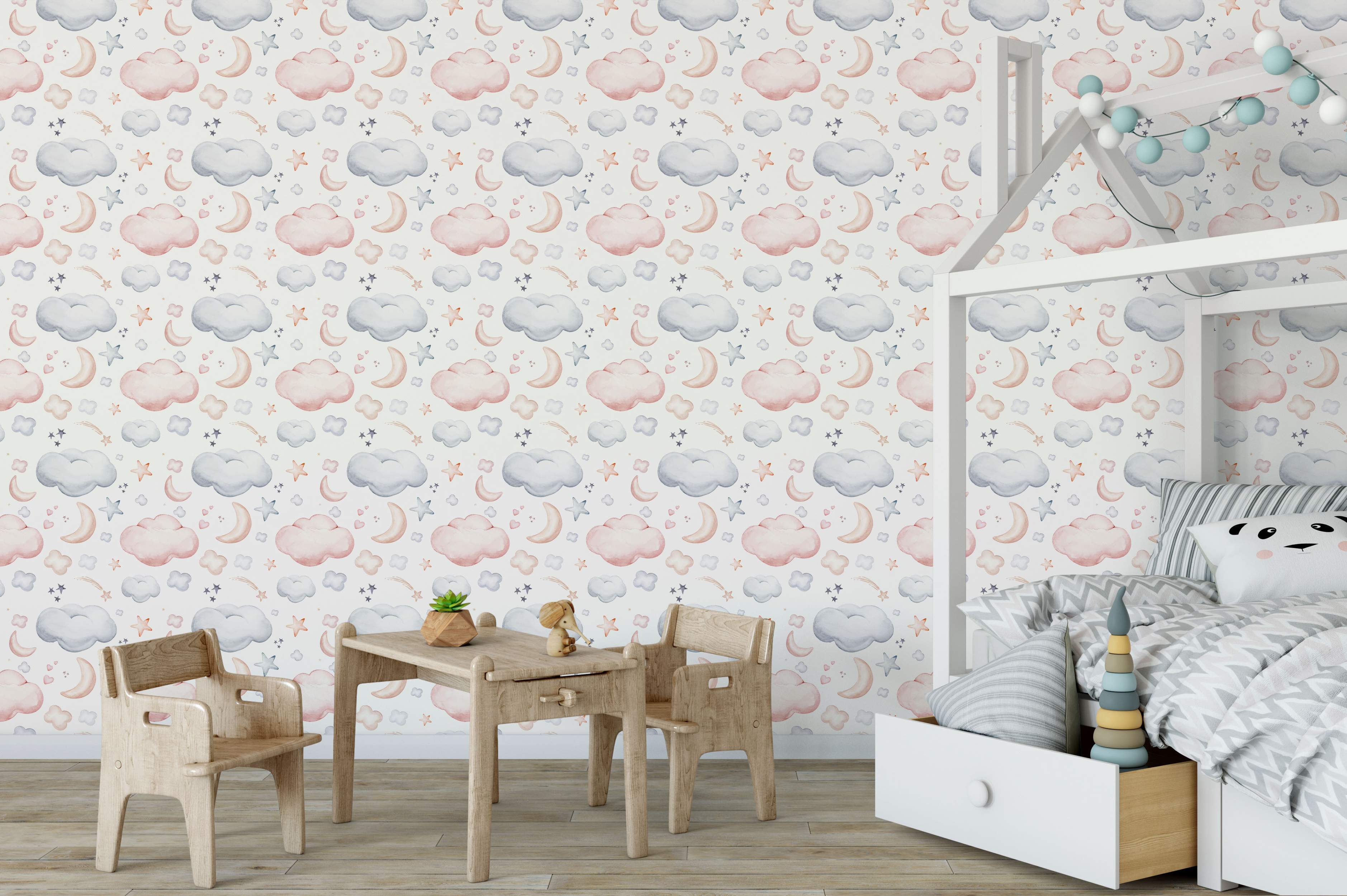 Wallpaper featuring a cute watercolor pattern of pink and blue clouds, crescent moons, and stars on a white background.
