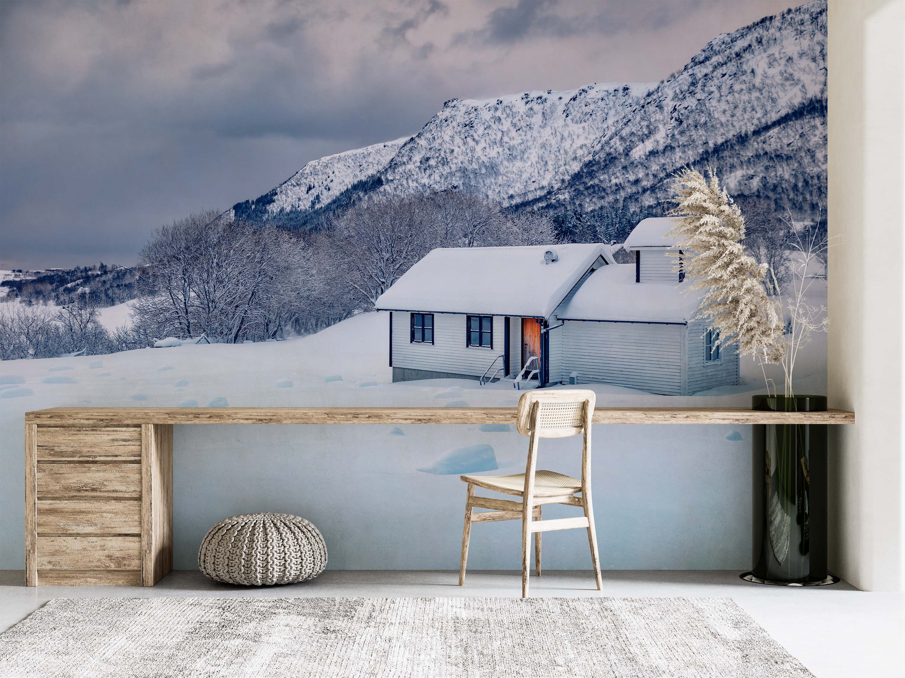 Photorealistic mural of a white house in a snowy landscape. Snow-covered mountains rise under a cloudy sky.