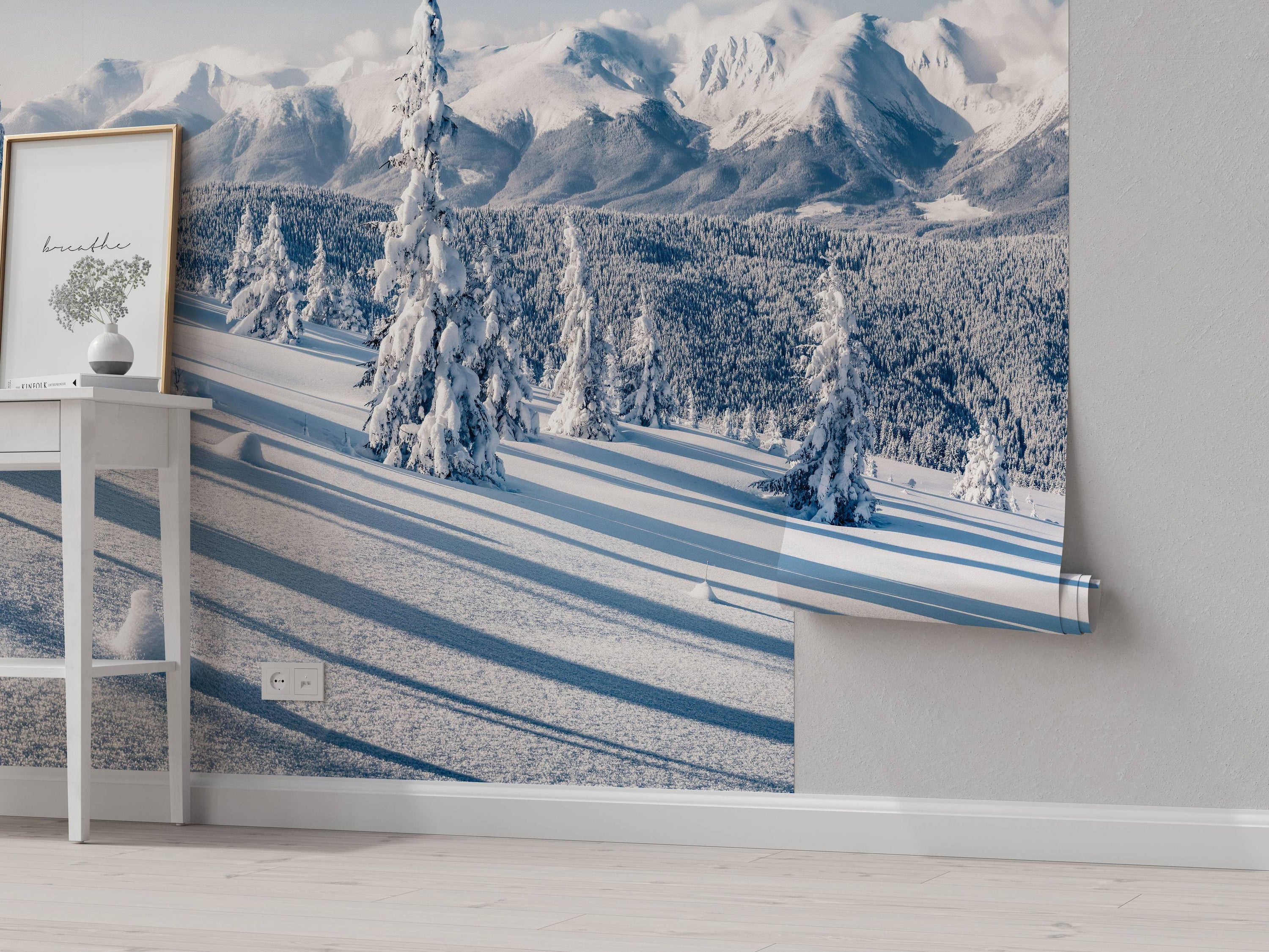 A photorealistic mural of a serene, snow-covered mountain landscape with evergreen trees and long, blue shadows.