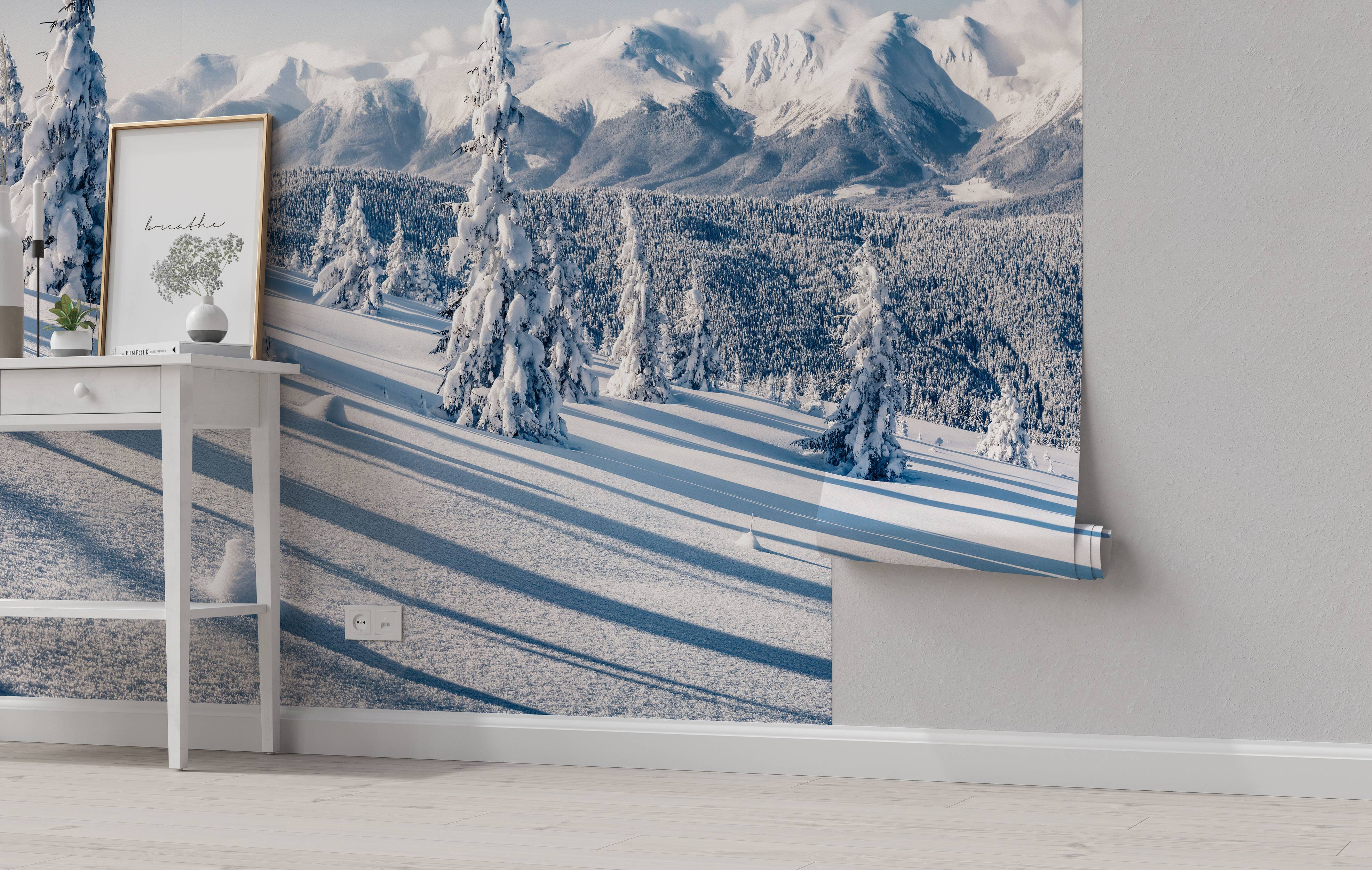 A photorealistic mural of a serene, snow-covered mountain landscape with evergreen trees and long, blue shadows.