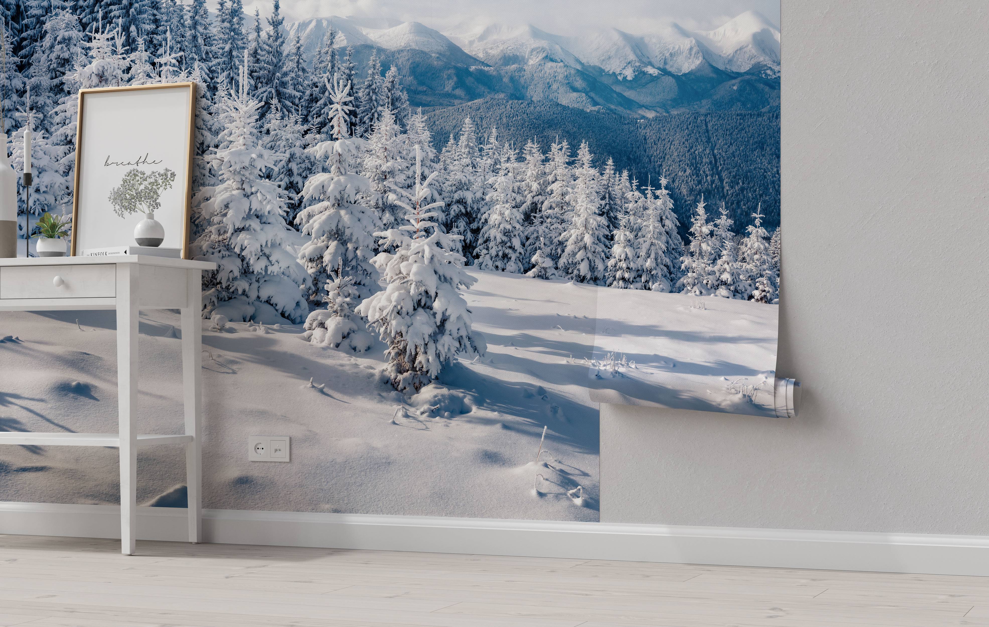 A photorealistic mural of a snowy mountain landscape with pine trees in the foreground and distant peaks in the background.