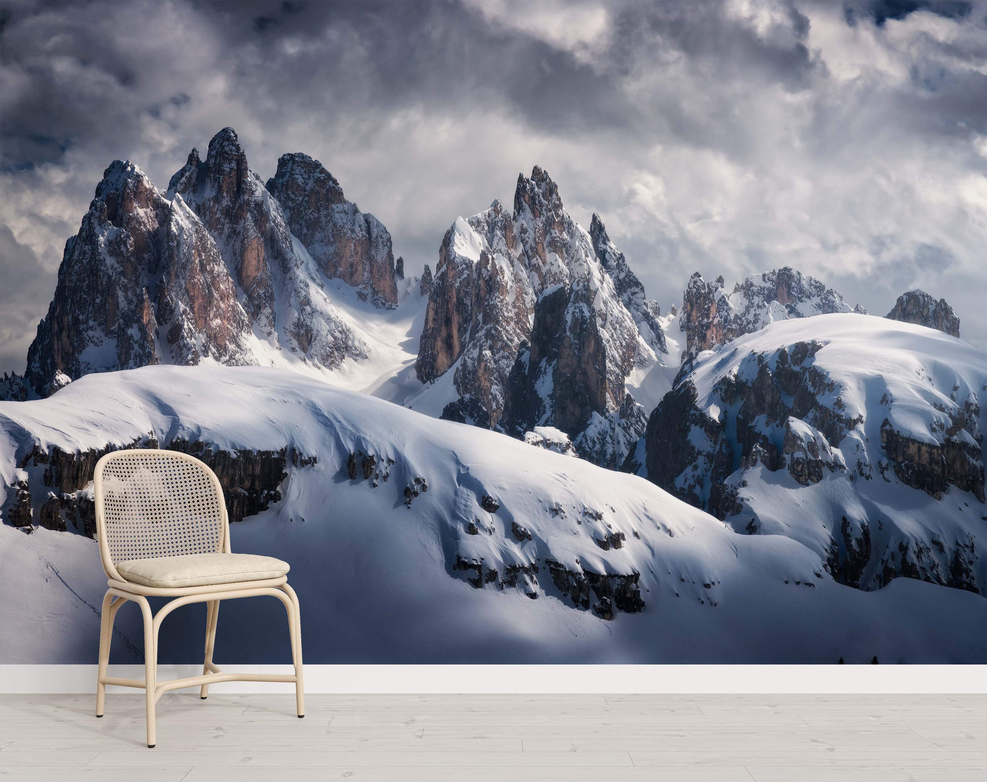 Photorealistic mural depicting majestic, snow-covered mountain peaks under a dramatic, cloudy sky.